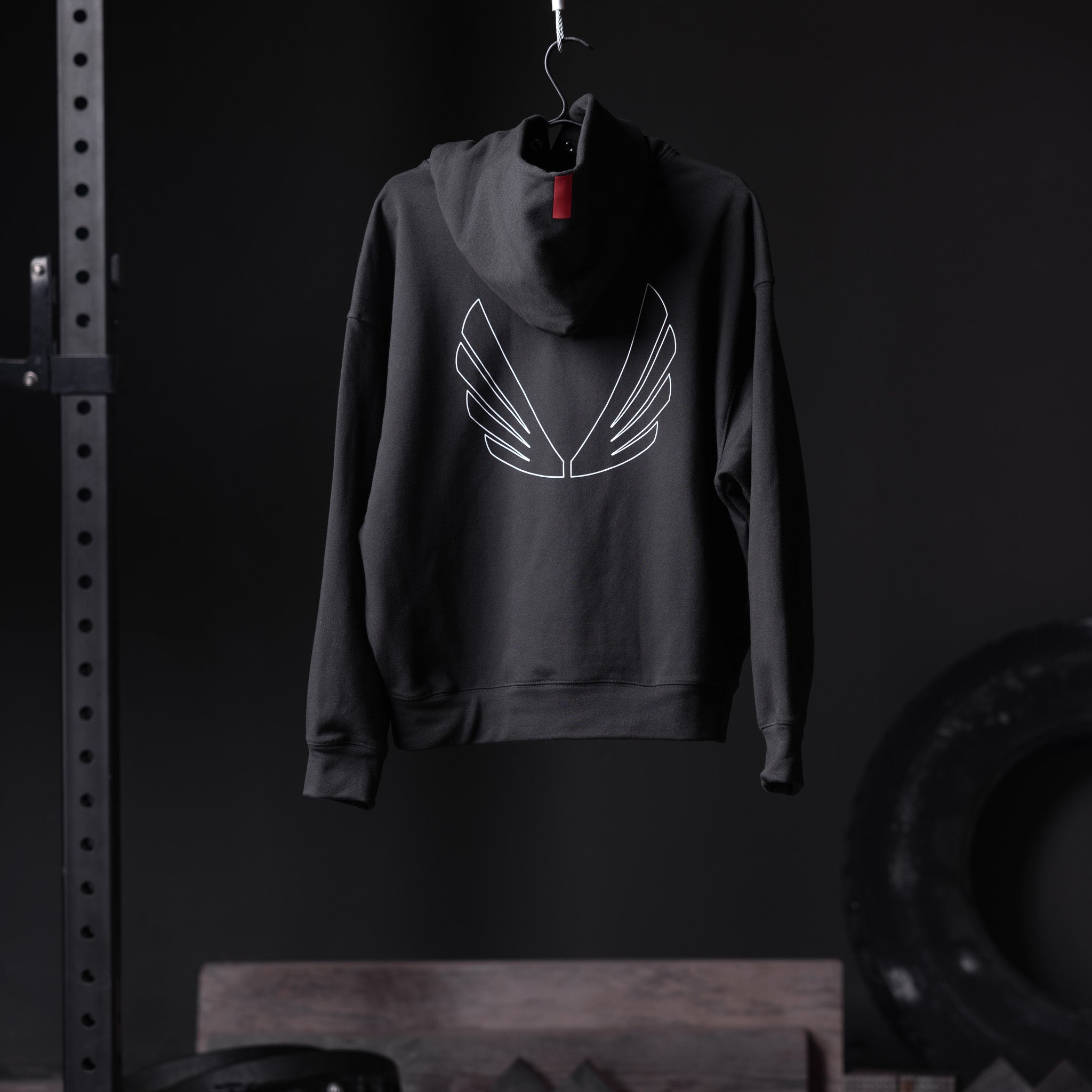 Flatlay Tech-Terry Zip Pocket Hoodie in black with outline wings graphic, back view