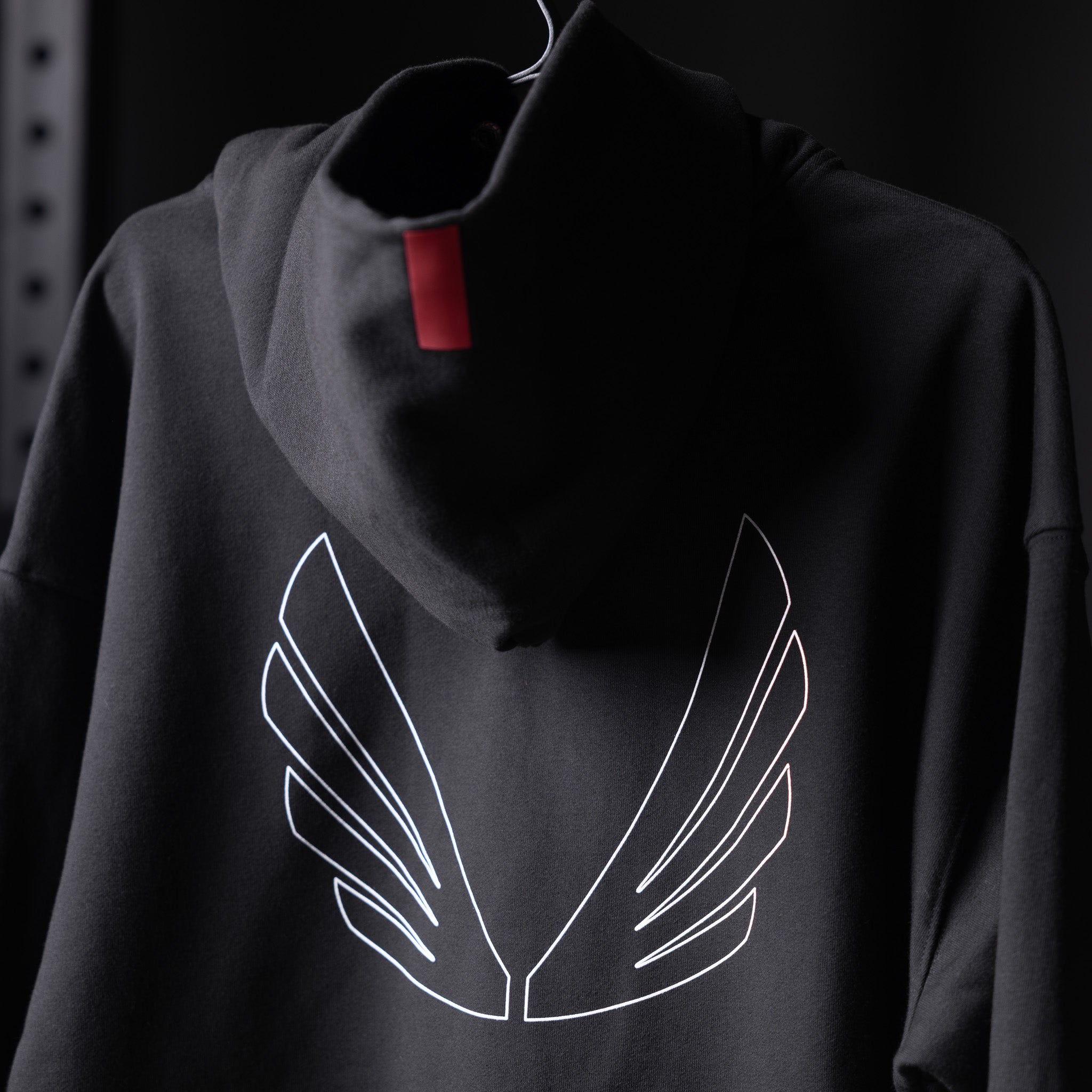 Tech-Terry Zip Pocket Hoodie in black with white wing outline graphic, displayed on mannequin