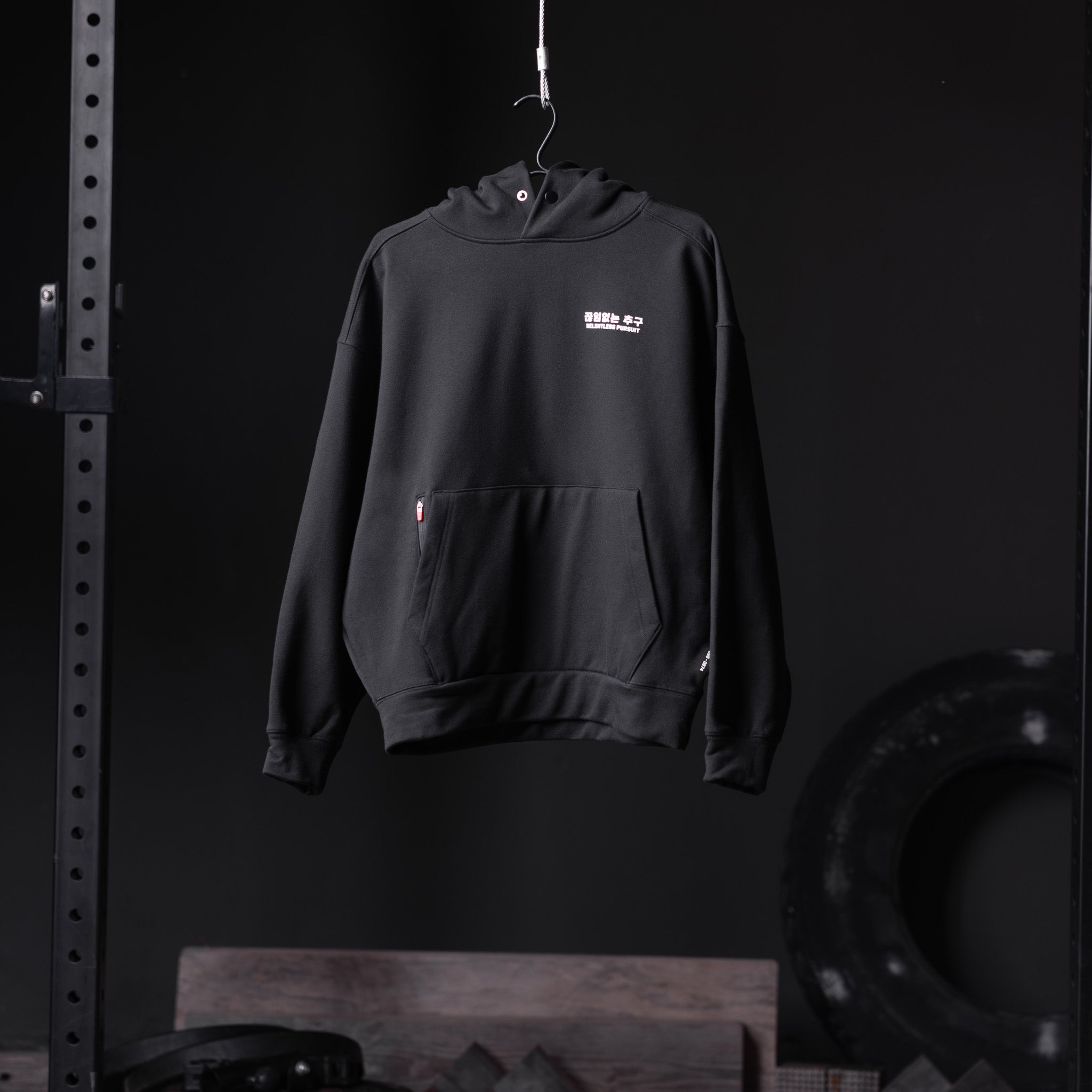Flatlay Tech-Terry Zip Pocket Hoodie in black, front view on hanger