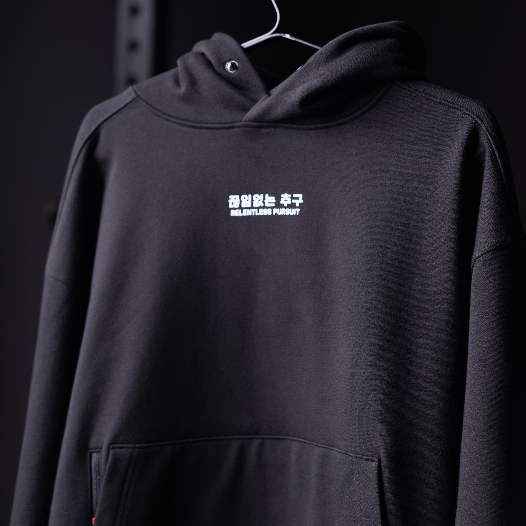 Flatlay Tech-Terry™ Zip Pocket Hoodie in black, front view on hanger
