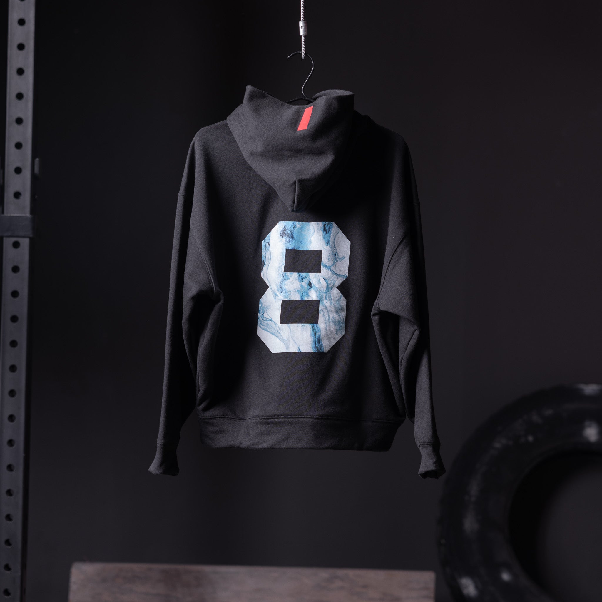 Flatlay Tech-Terry™ Zip Pocket Hoodie in black with marble 8 graphic, back view