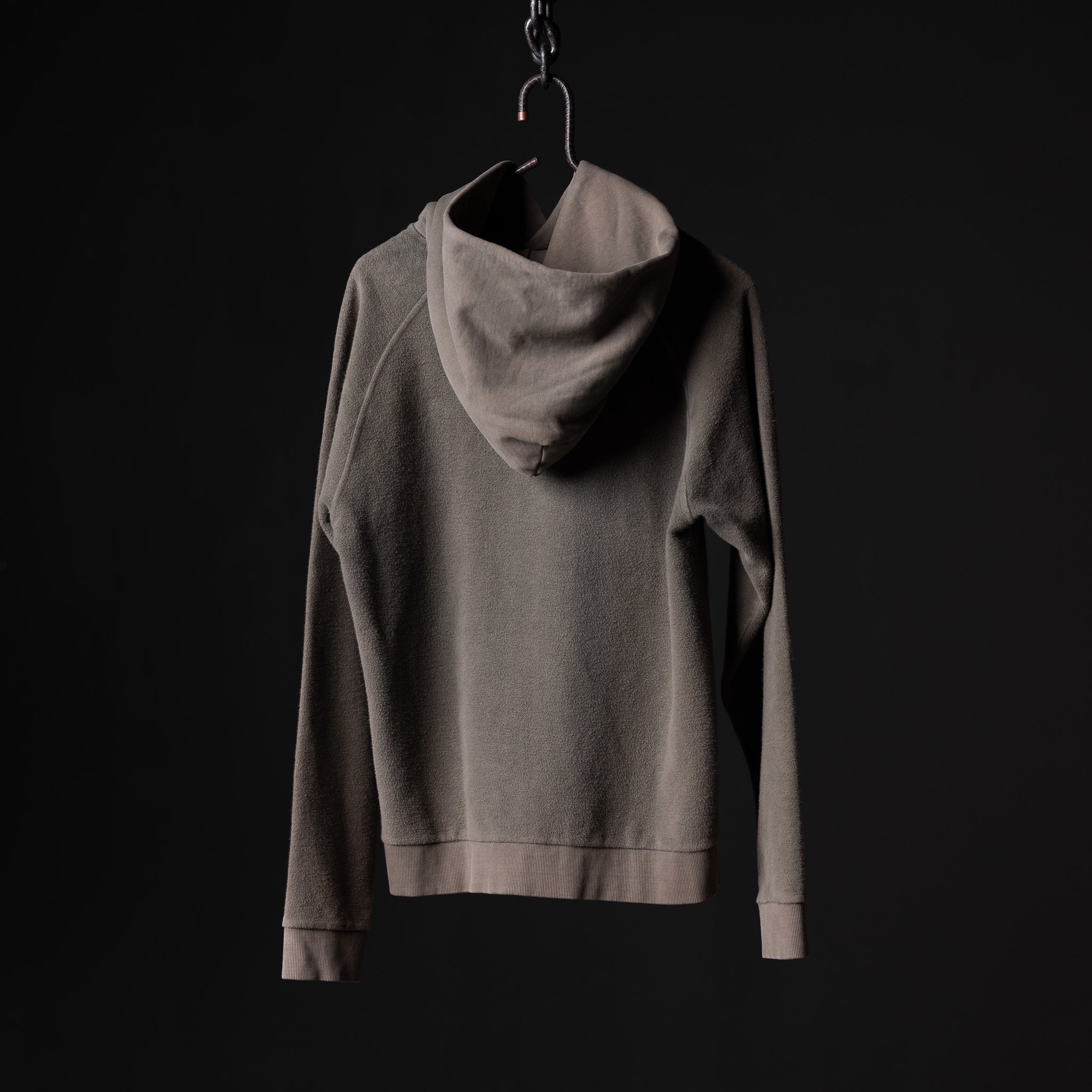 SS'20 Reverse Weave Hoodie in grey displayed on hanger against black background