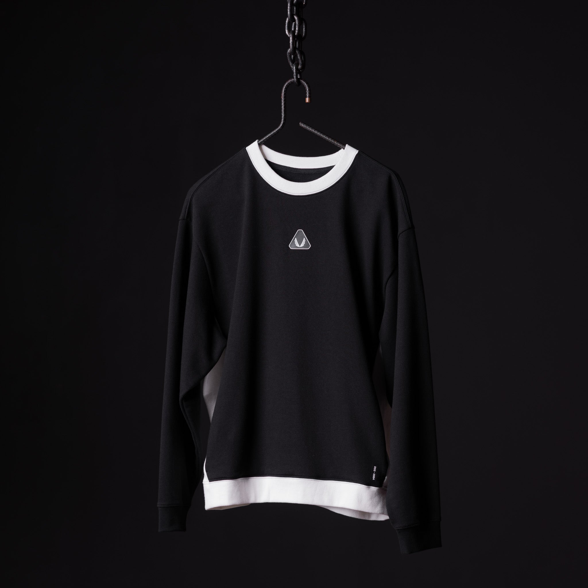 Black Terry Crew Neck sweatshirt with white trim displayed on hanger against dark background