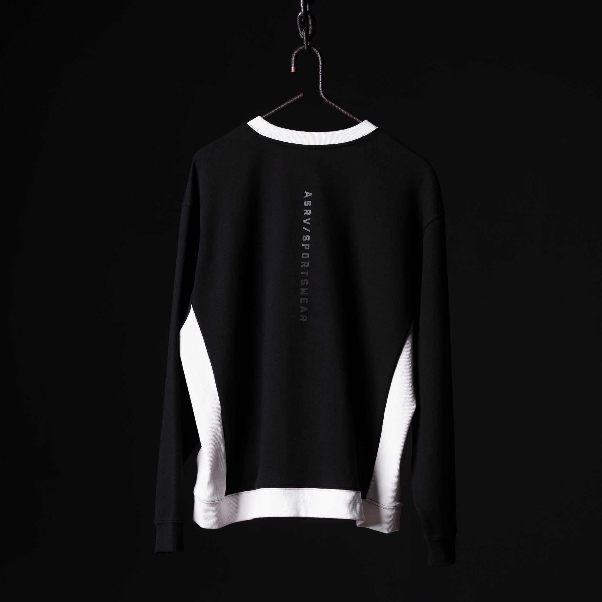 Black and white Terry Crew Neck sweatshirt on hanger, back view showing vertical text branding