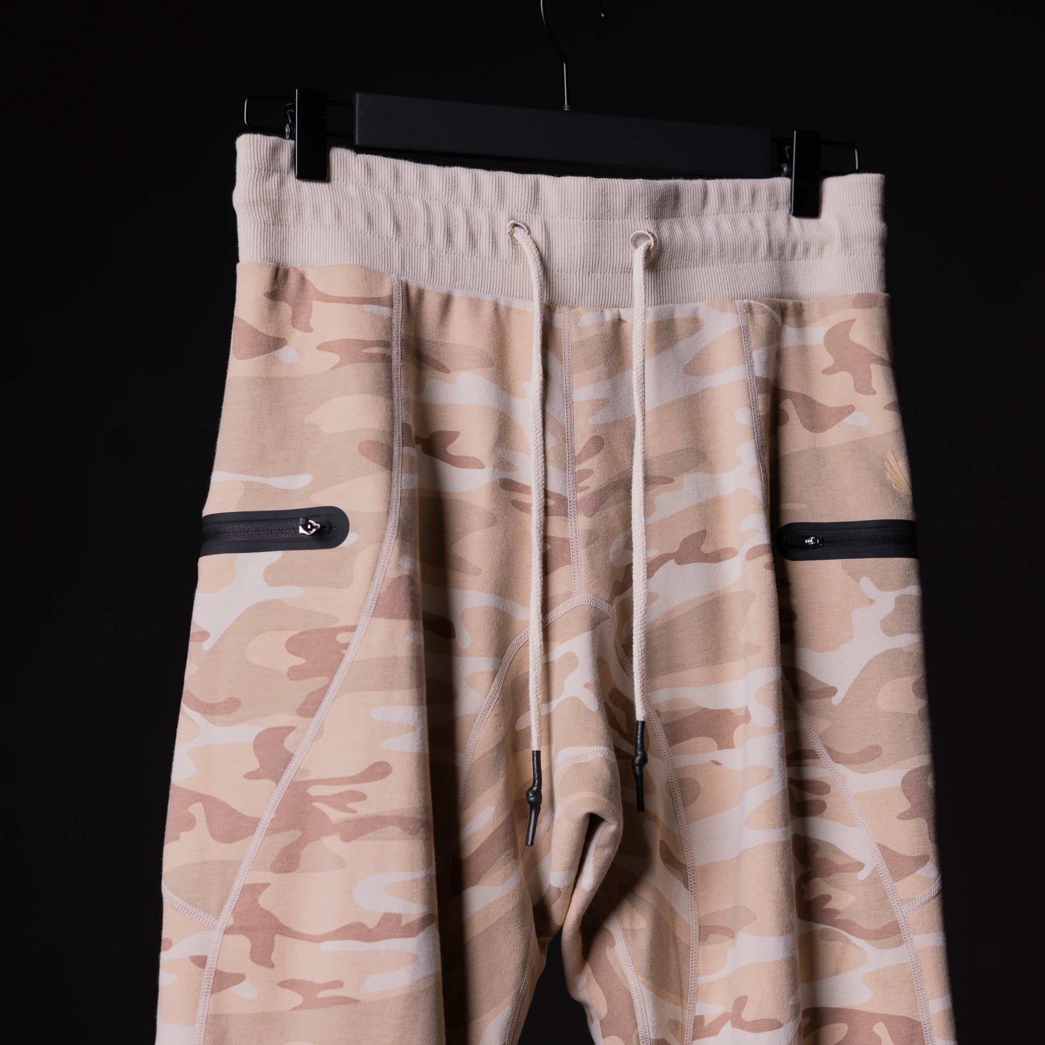 SP'19 Sidelock Utility Jogger in tan camouflage, hung on display against black background
