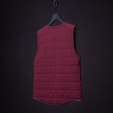 FA'22 Adventure Vest in burgundy displayed on hanger against dark background