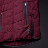 FA'22 Adventure Vest in burgundy, detail shot of zipper pockets and quilted design