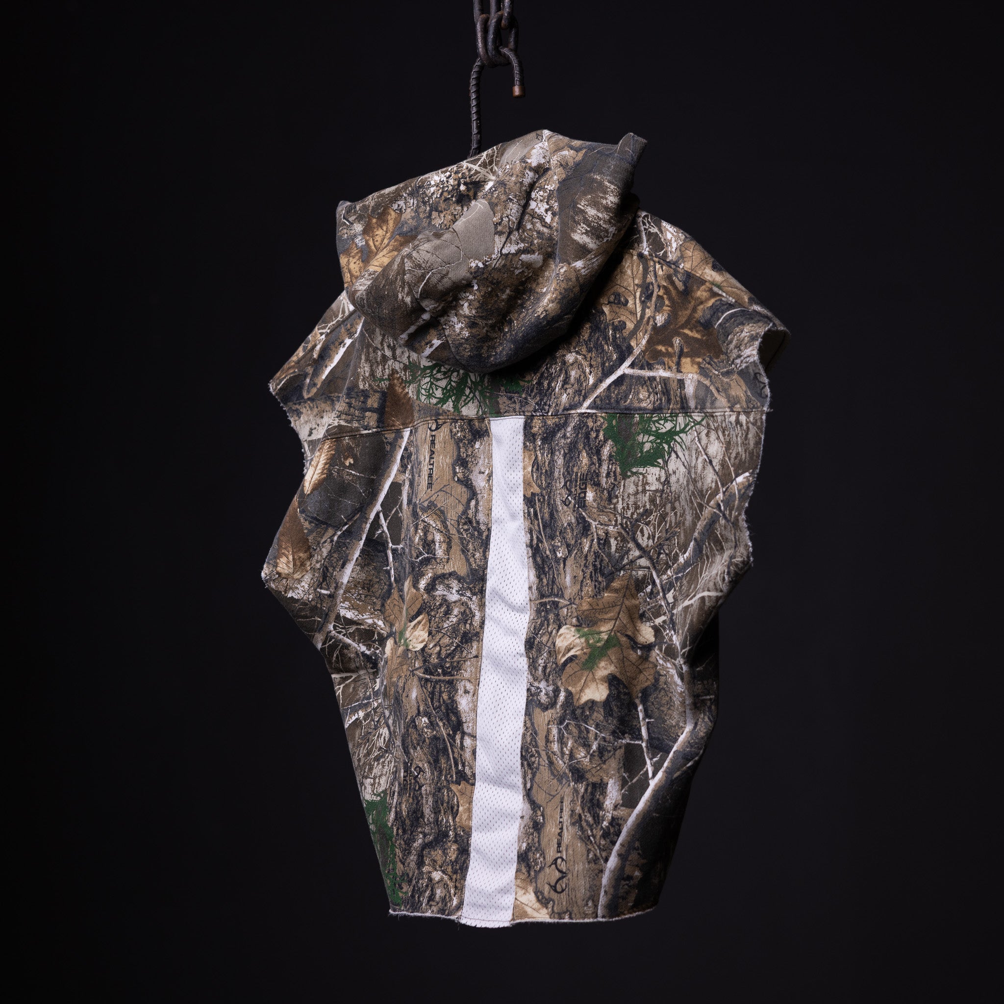 Raw Hem Cutoff Hoodie in realtree camo with white stripe, displayed on hanger against black background
