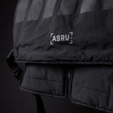 2018 Technical Vest in black, detail shot of ASRV branding and quilted fabric