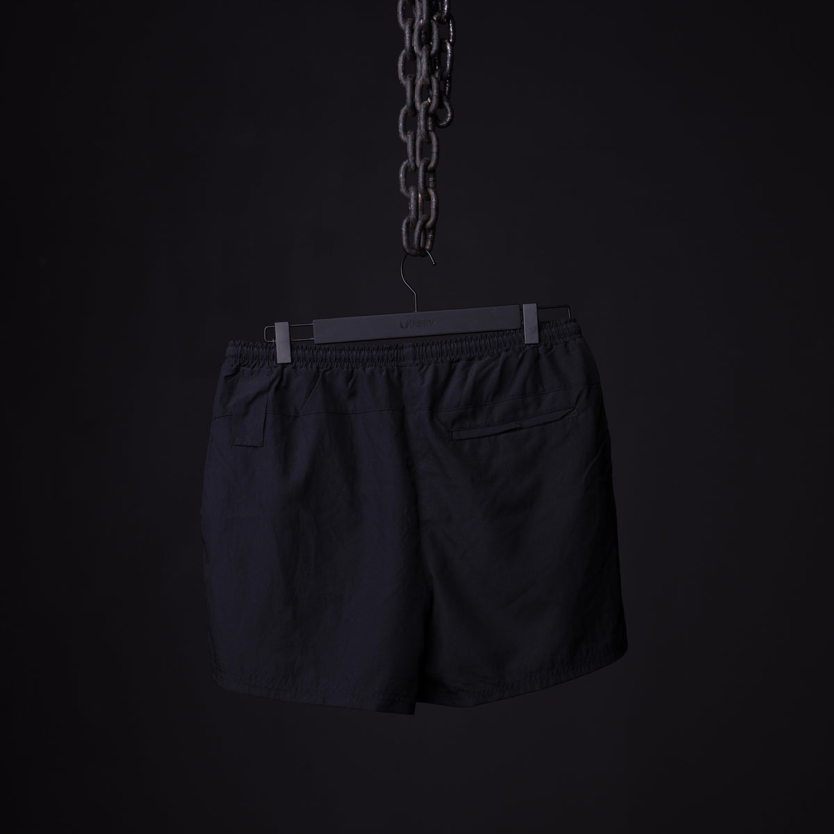 SP'22 Vintage 5" Training Short in black, displayed on hanger against dark background