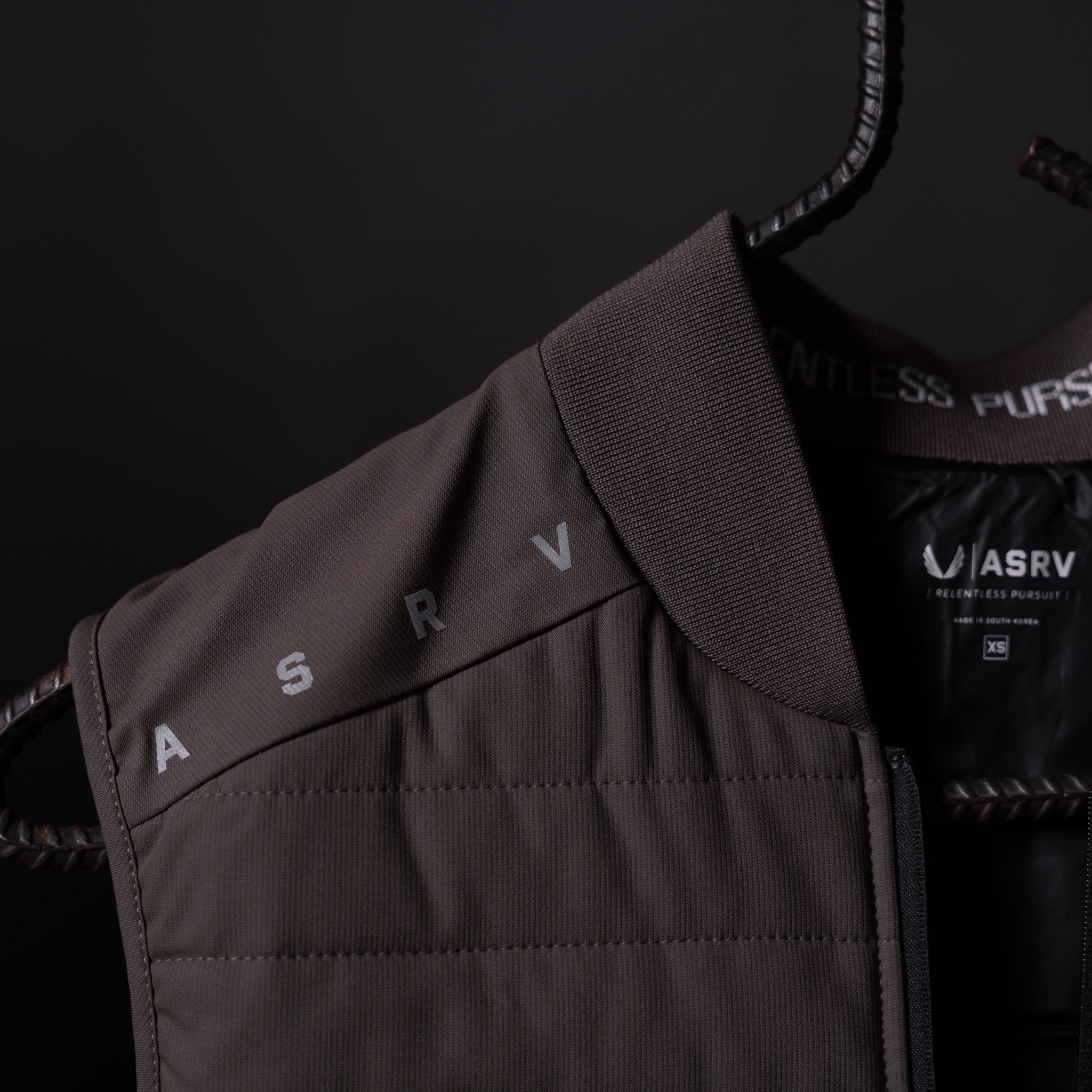 SP'23 Waterproof Run Vest in charcoal gray, displayed on hanger showing front detail