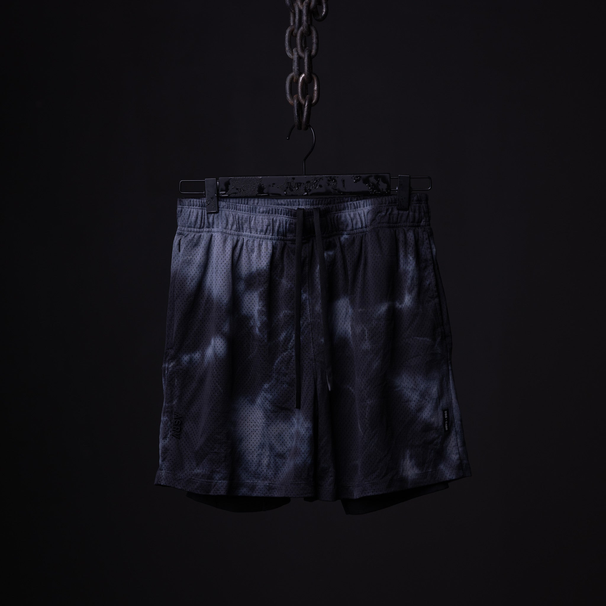 SM'21 Tie Dye Mesh Liner Short in navy, hanging from chain against black background
