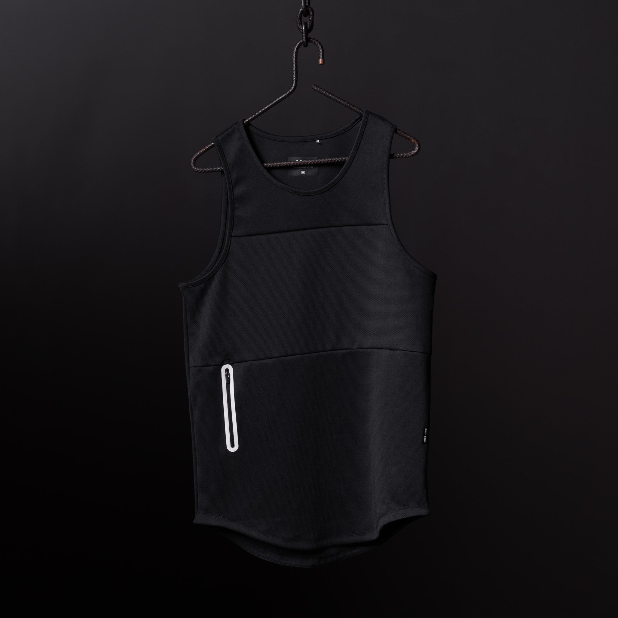 Black mesh utility tank on hanger against dark background, front view