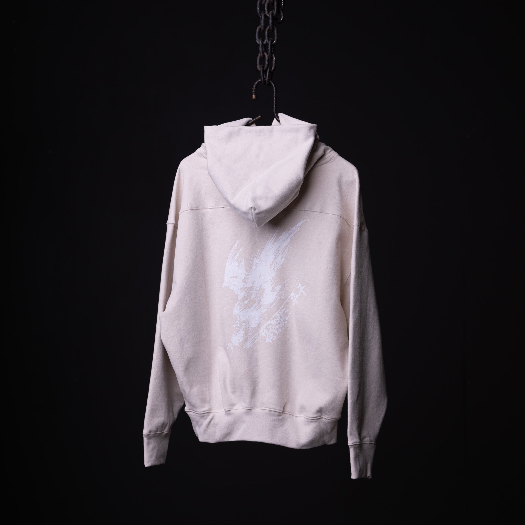 FA'22 Tech Terry Eagle Hoodie in cream, hung on chain against black background