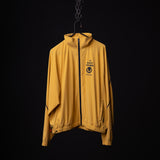 SM'24 Track Jacket in mustard yellow, displayed on hanger against black background