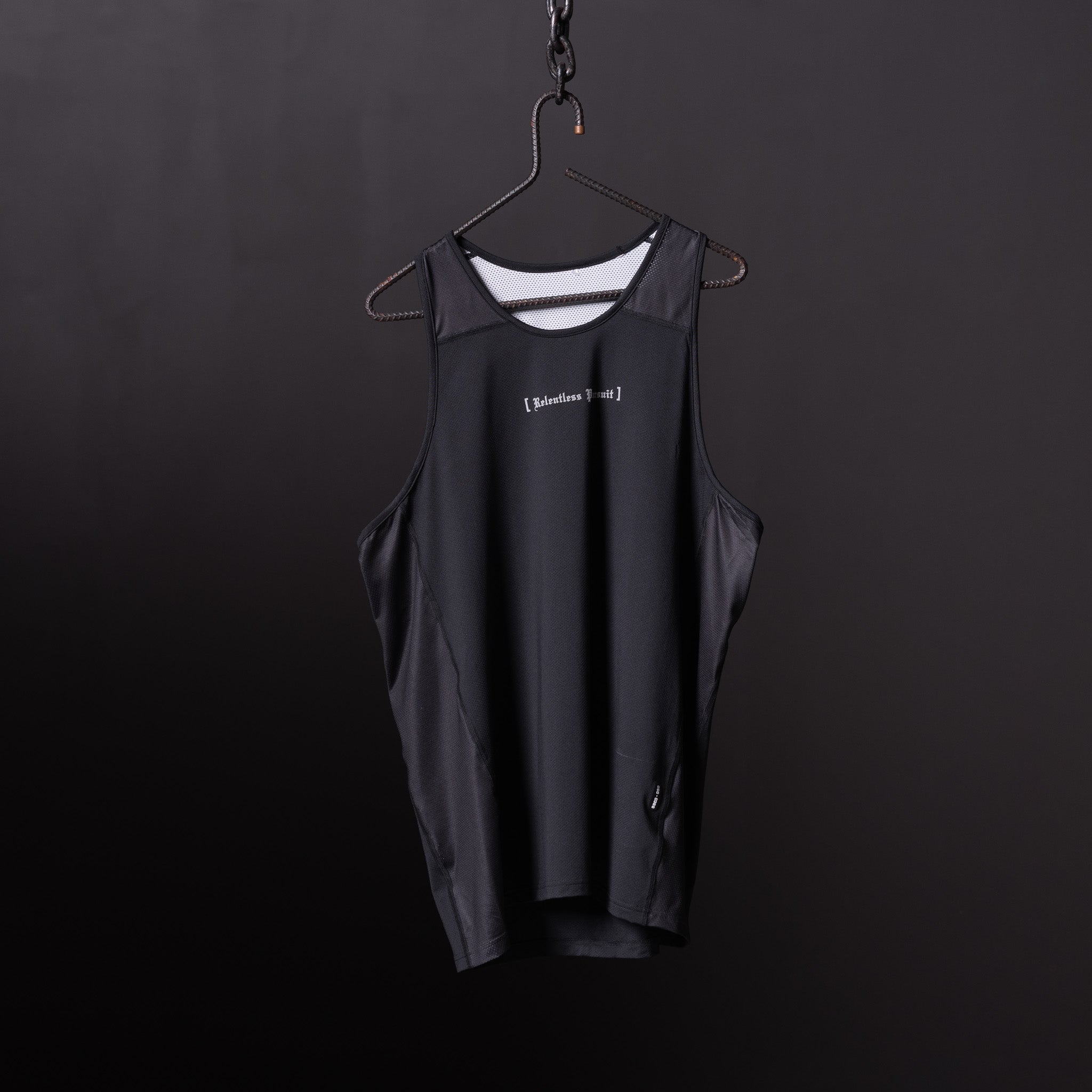 Black singlet tank on hanger against dark background, front view