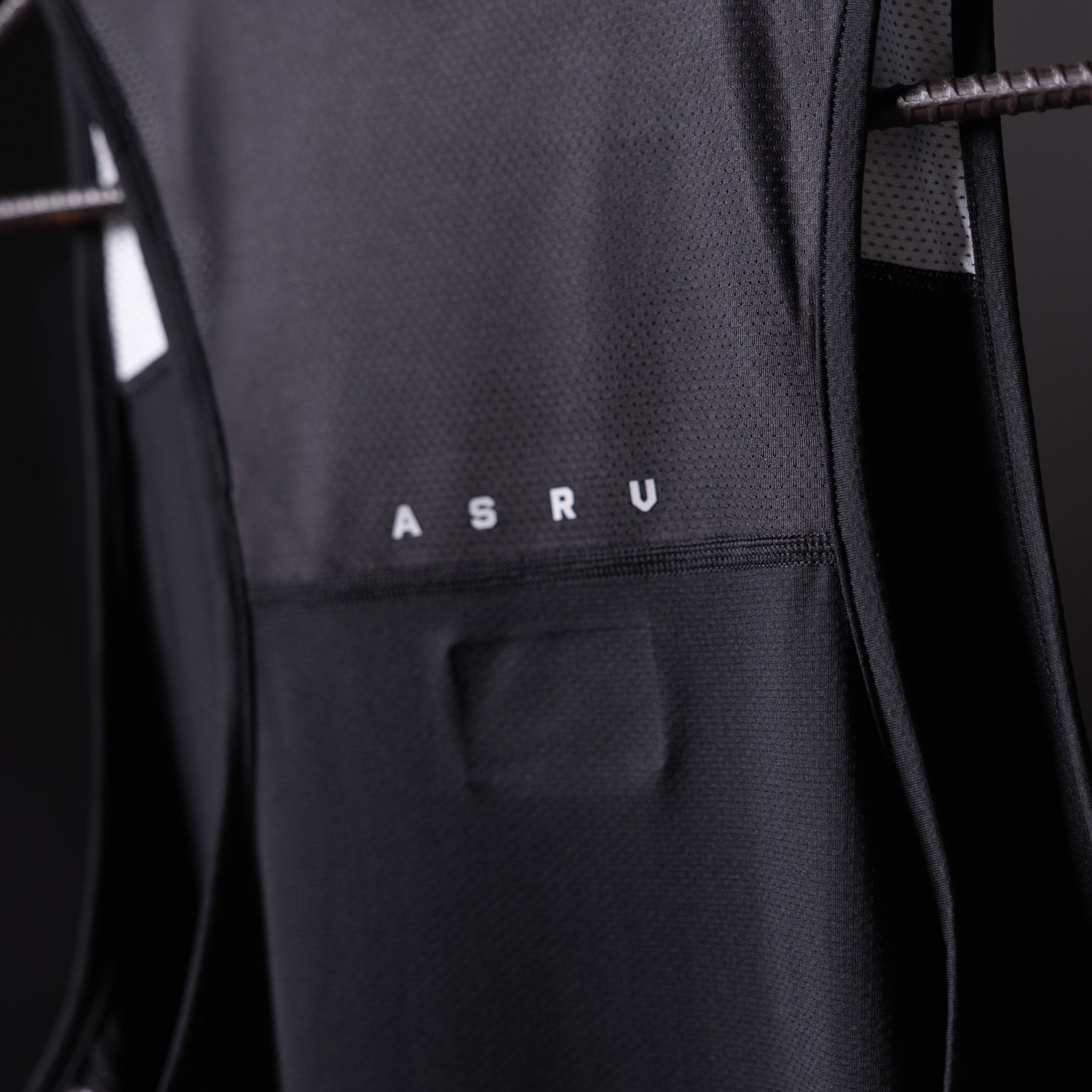 SM'19 Singlet Tank in black, close-up detail shot showing ASRU branding and fabric texture