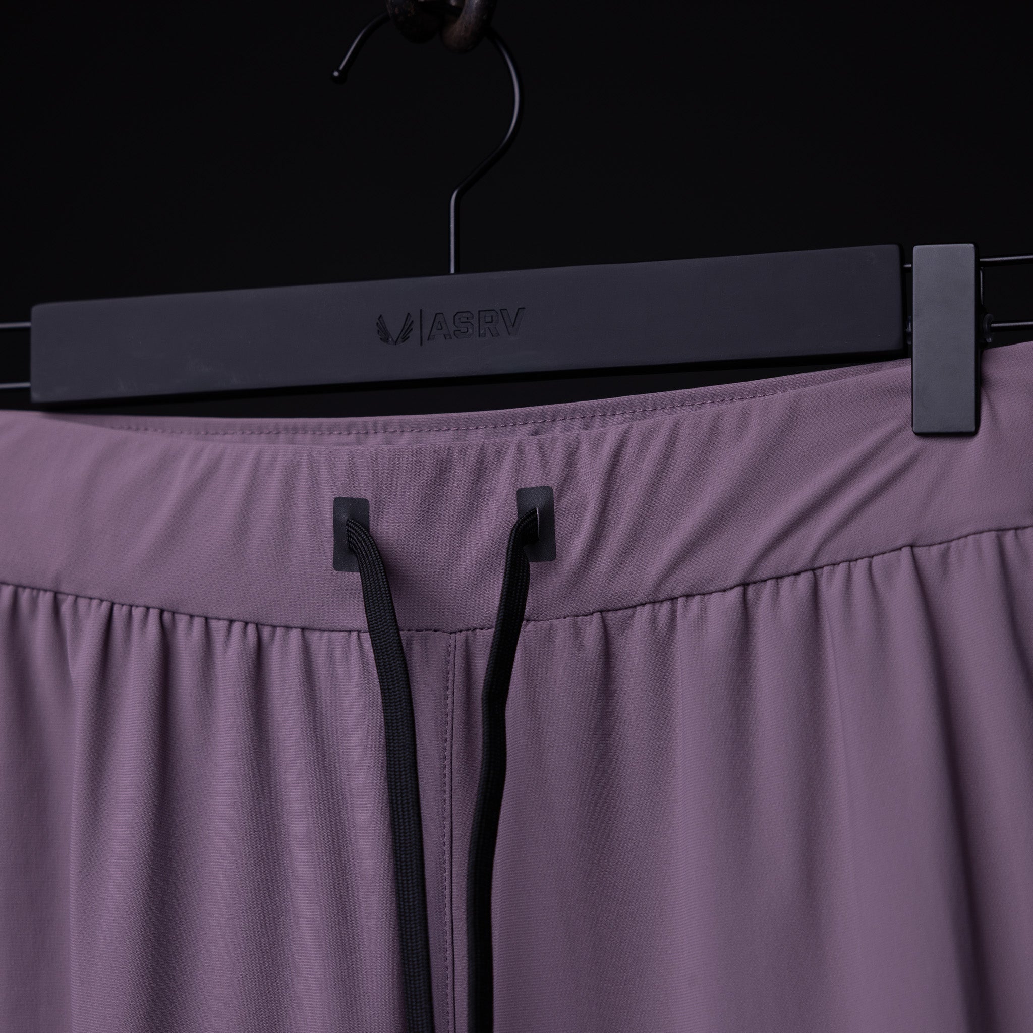 WN'23 Cyber Tech High Rib Jogger in mauve hung on black hanger, front detail view