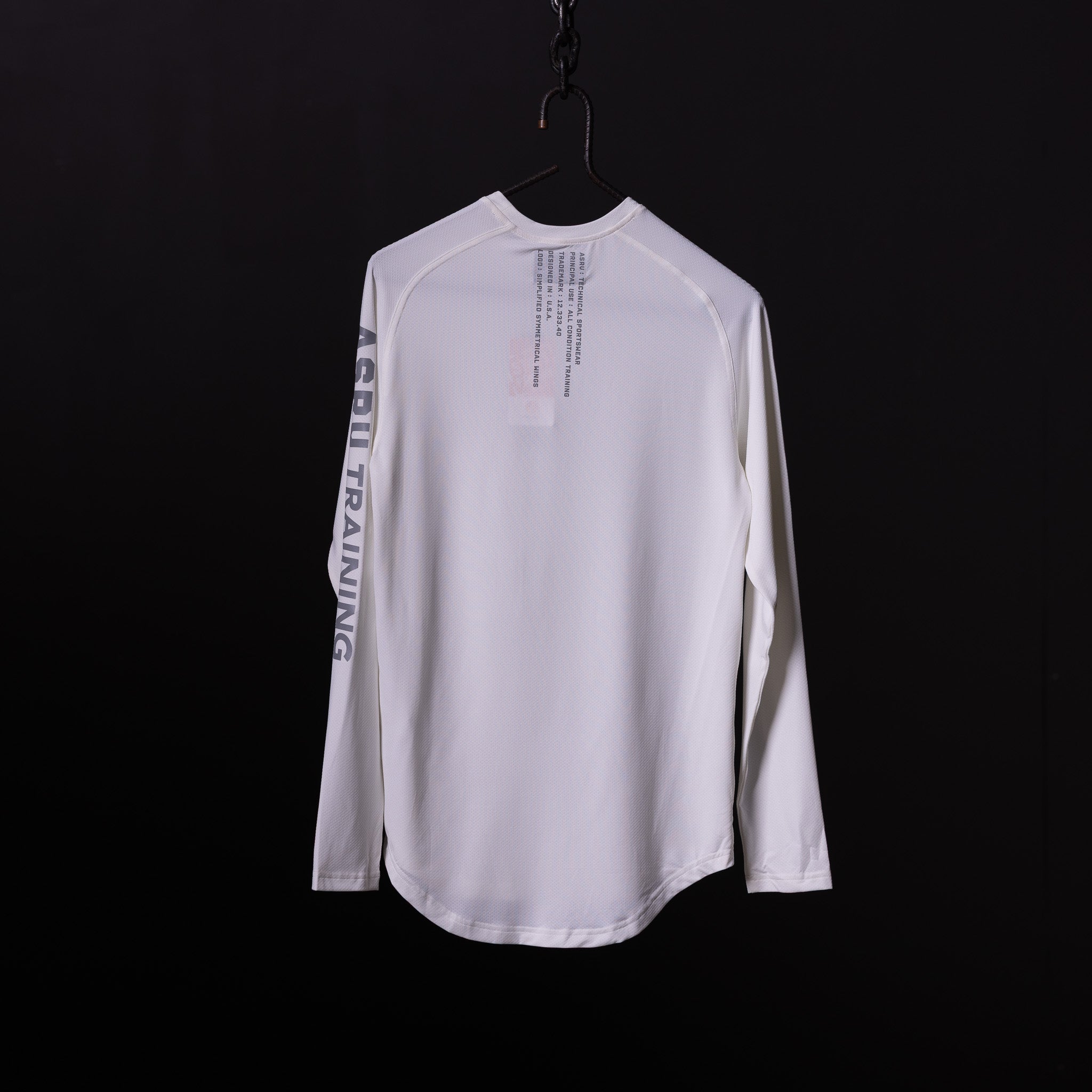 SP'20 long sleeve shirt in white, displayed on hanger against black background