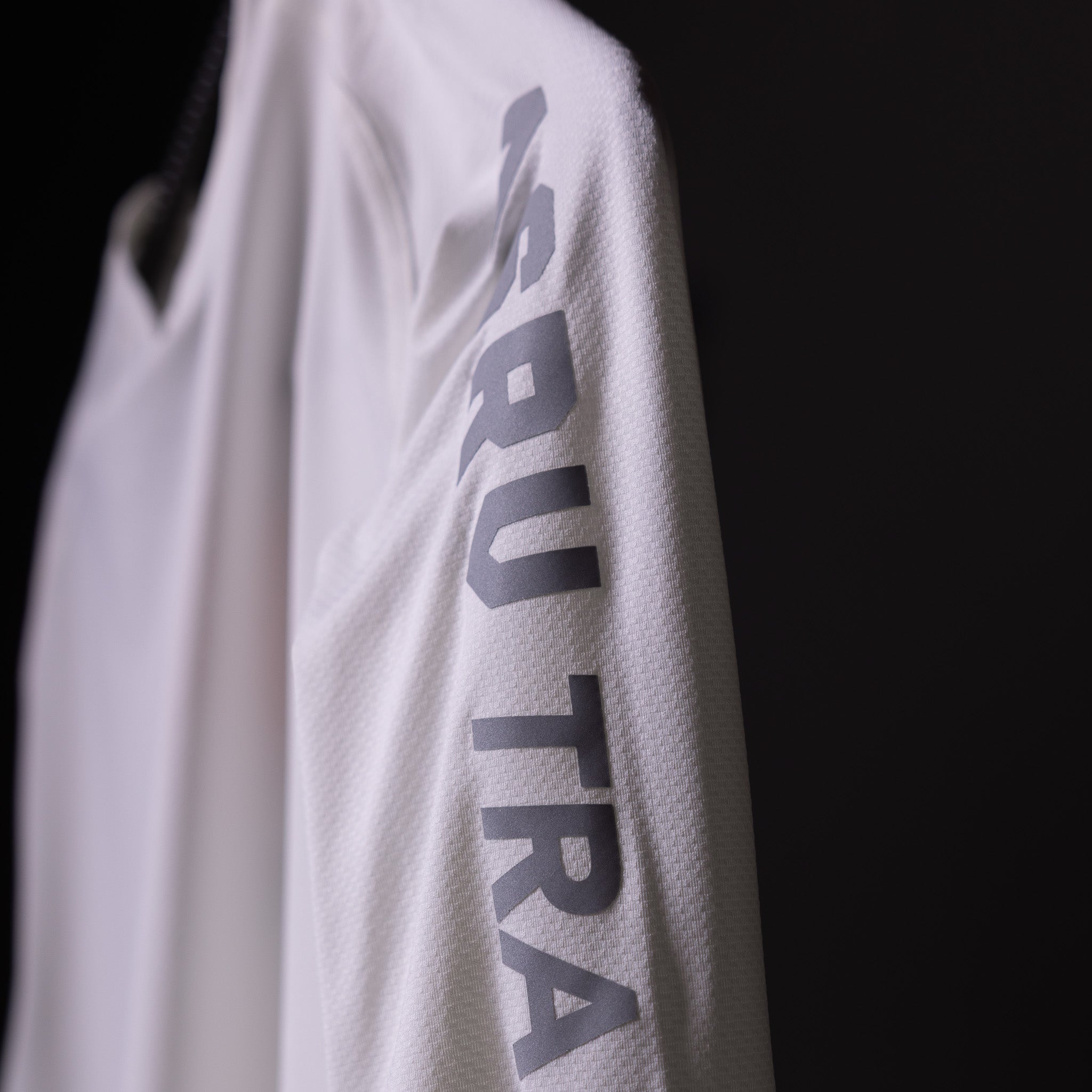SP'20 long sleeve shirt in white worn on model, sleeve detail showing ASRV branding