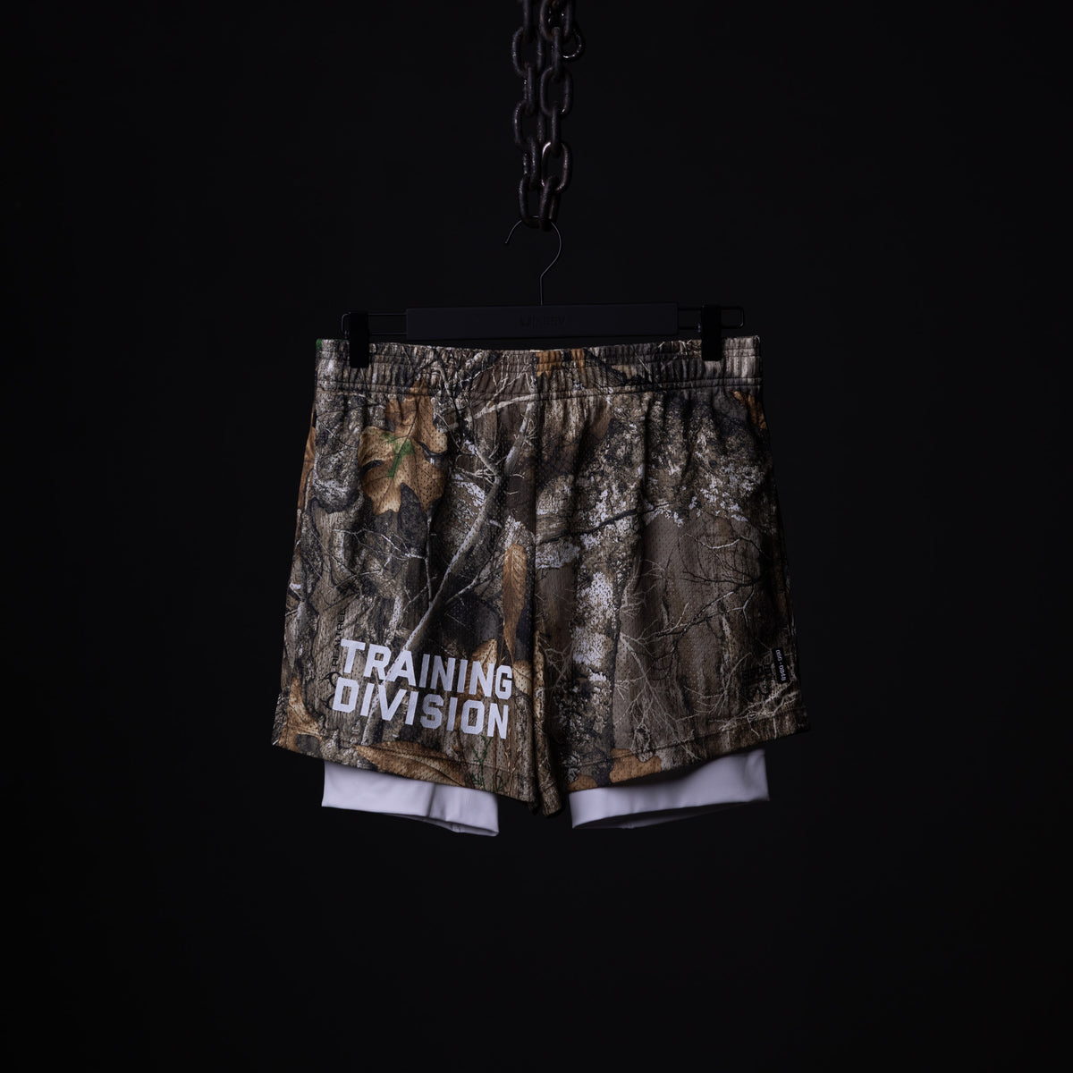 Training Division mesh shorts in camo and white, front view hanging on chain