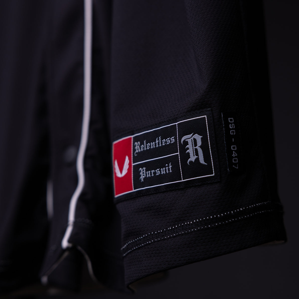 FA'21 Reversible Jersey label closeup detail on black fabric