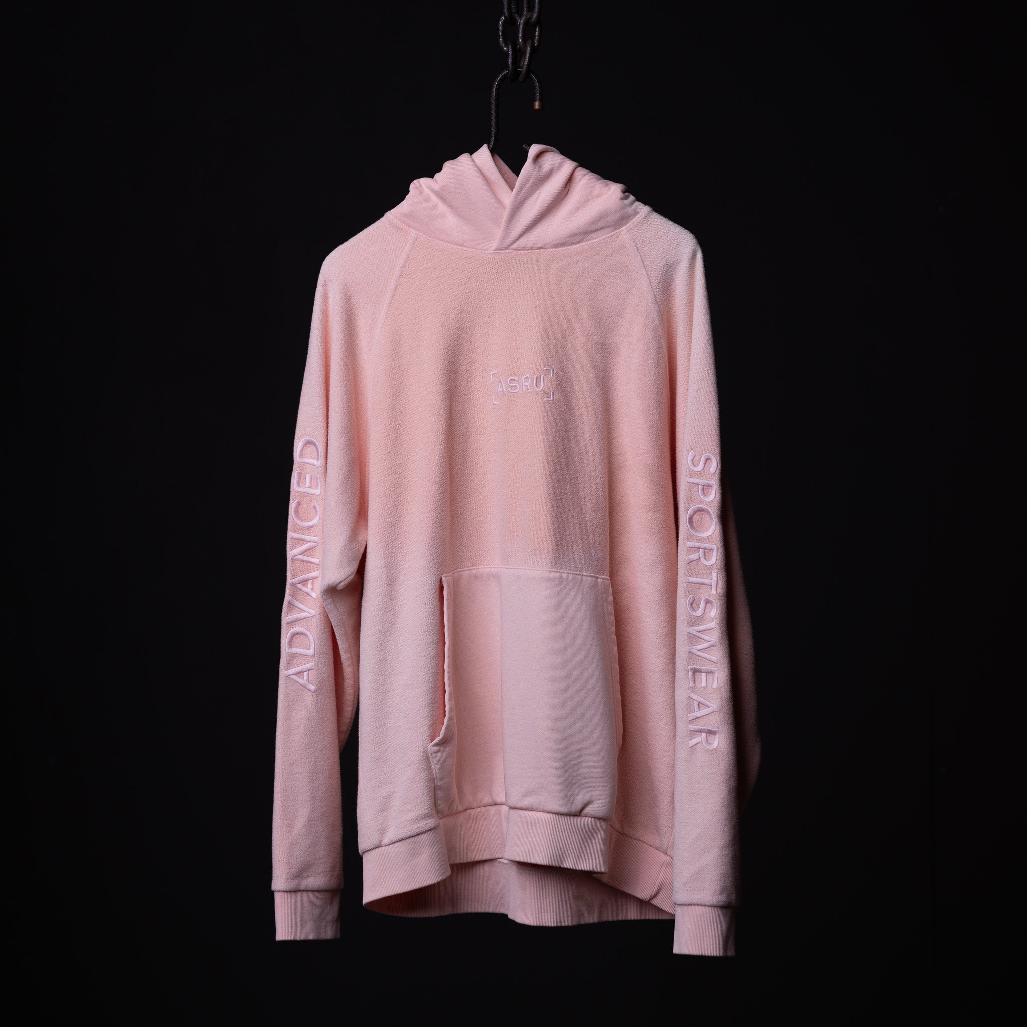 SS'20 Reverse Weave Hoodie in pink, displayed on hanger against black background