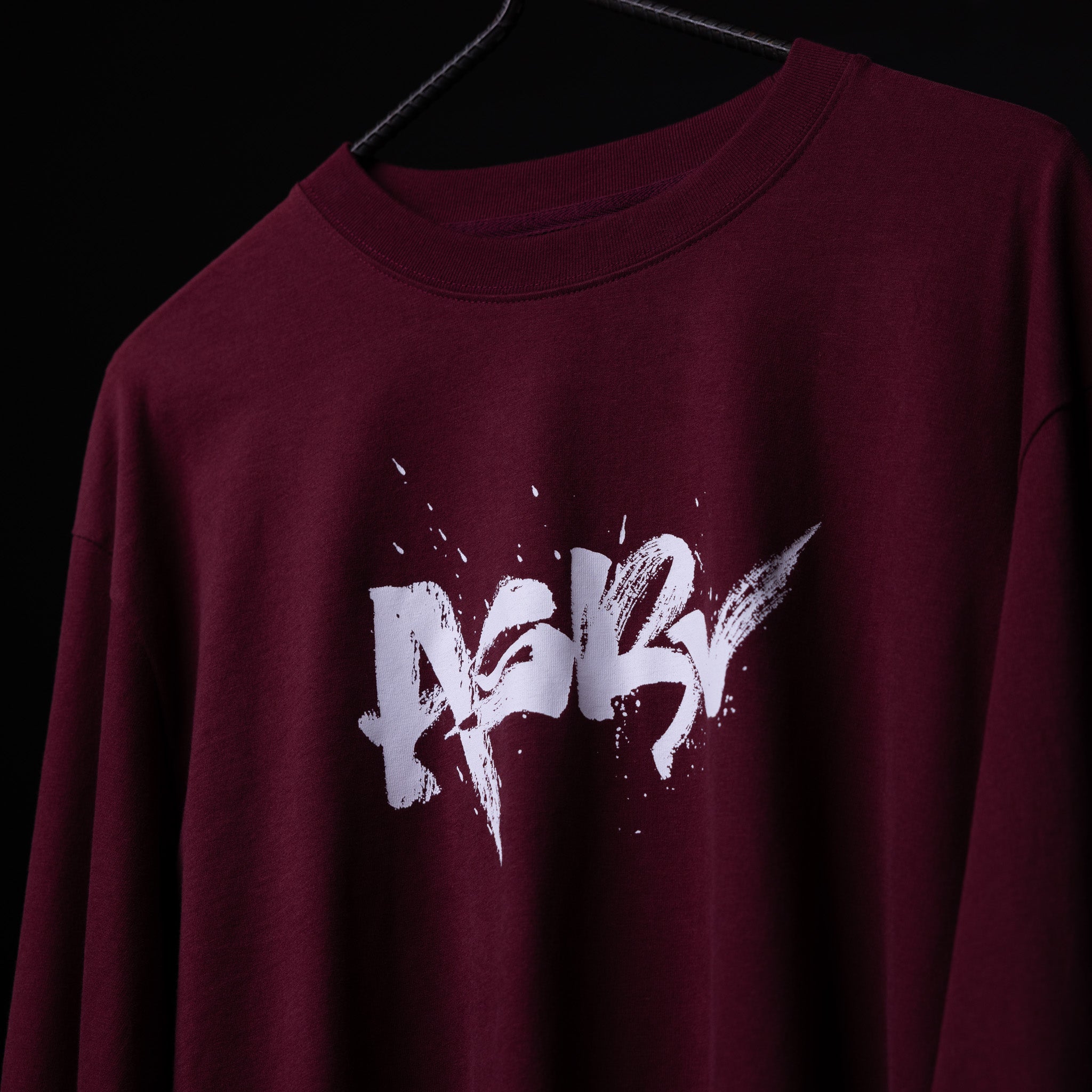 SM'22 Graphic Long Sleeve in maroon on hanger, front view