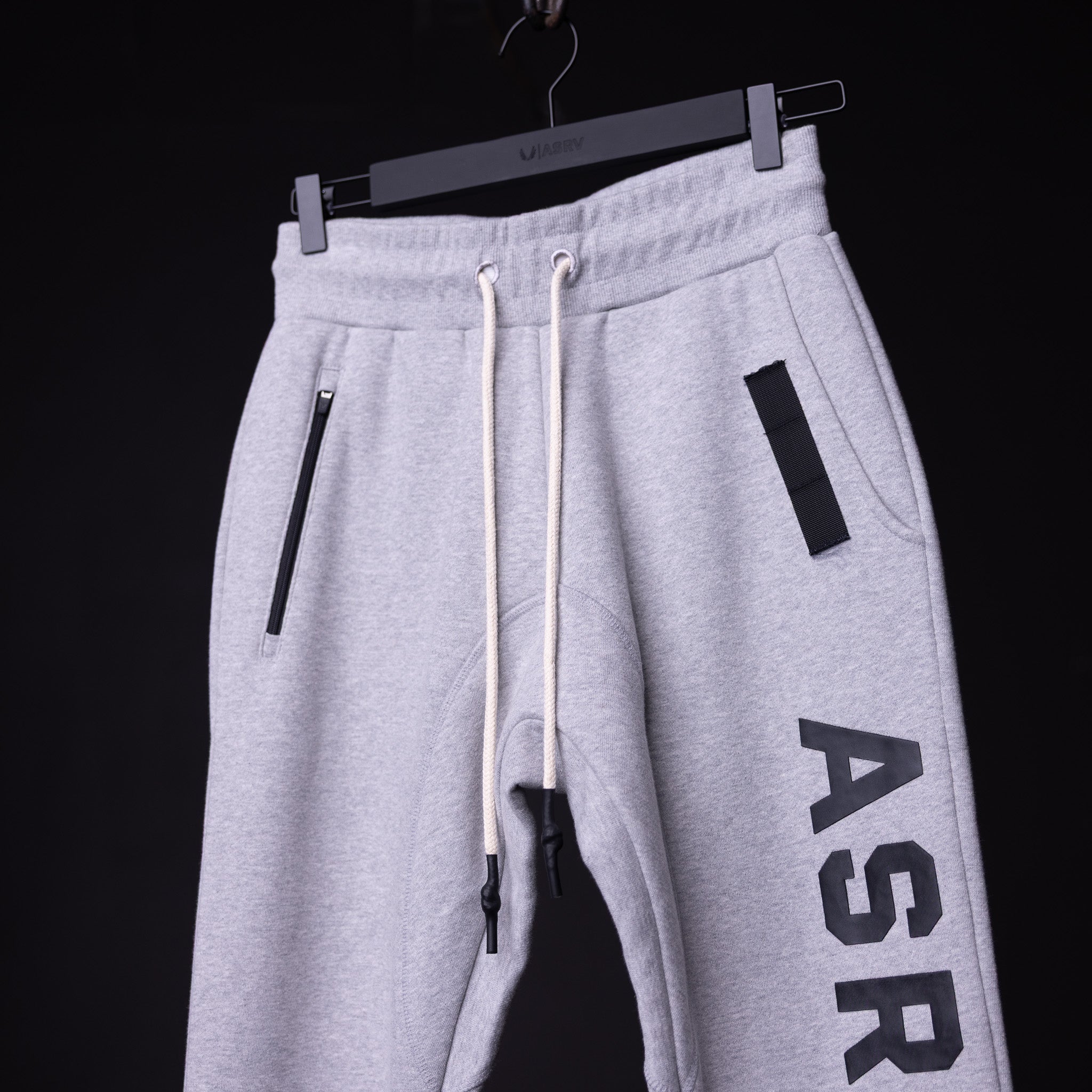 WN'19 RainPlus® Jogger in light grey, displayed on hanger showing side view with branding
