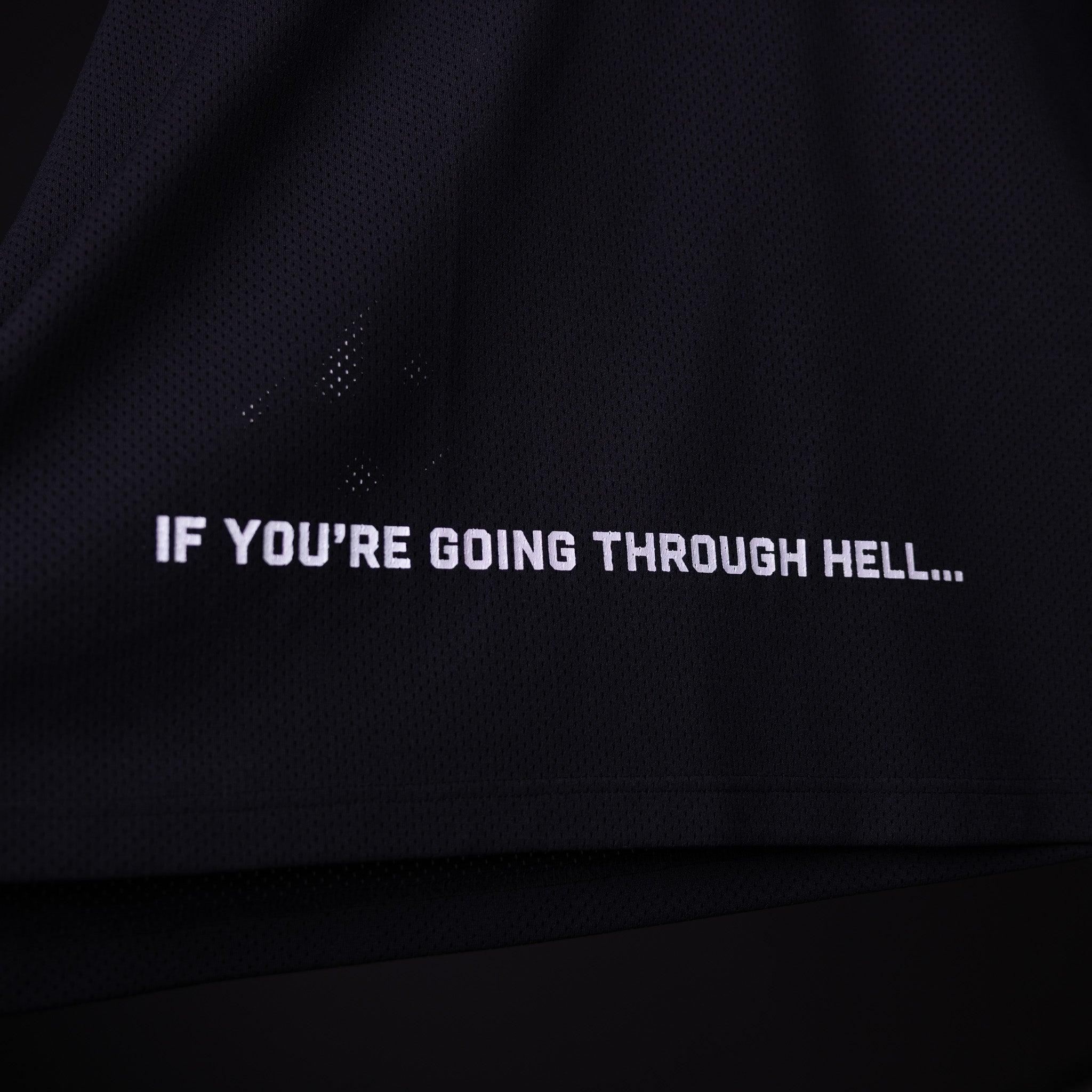 SM'23 long-sleeve jersey in black, worn and displaying motivational text graphic