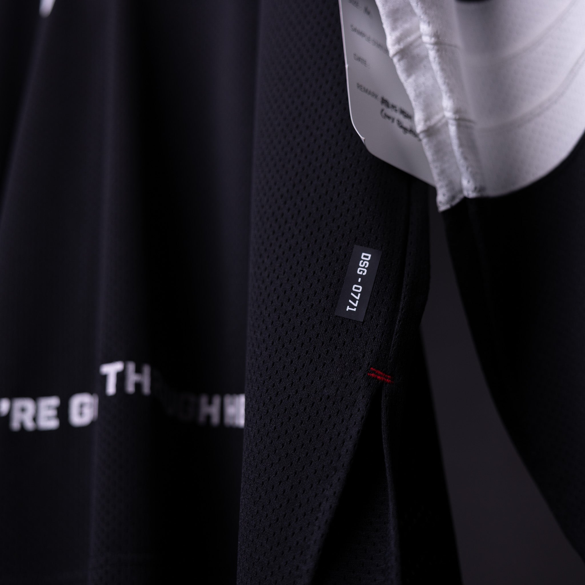 SM'23 Long-sleeve Jersey in black, detail shot of fabric texture and care label