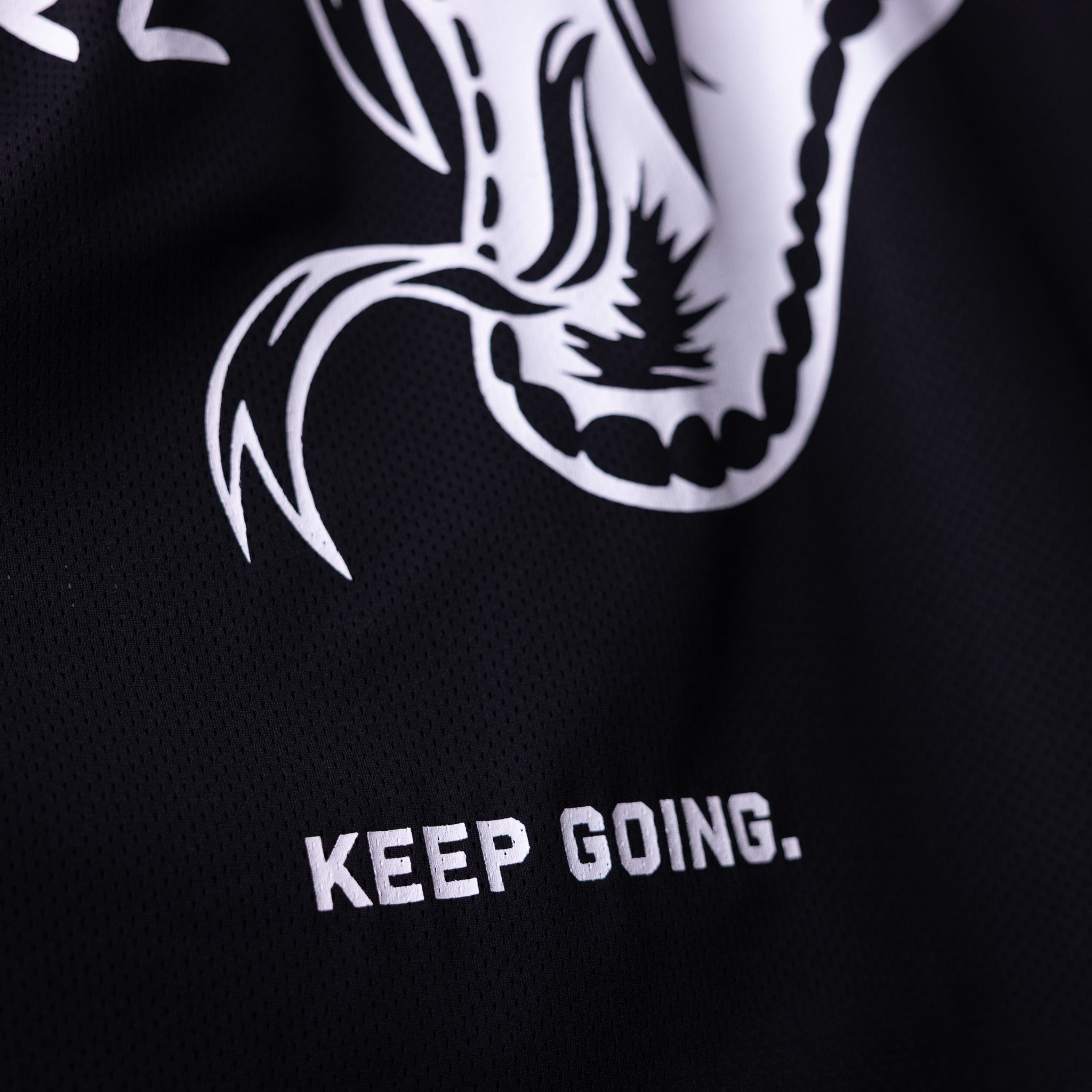 SM'23 long-sleeve jersey in black with white graphic and 'Keep Going' text, detail shot