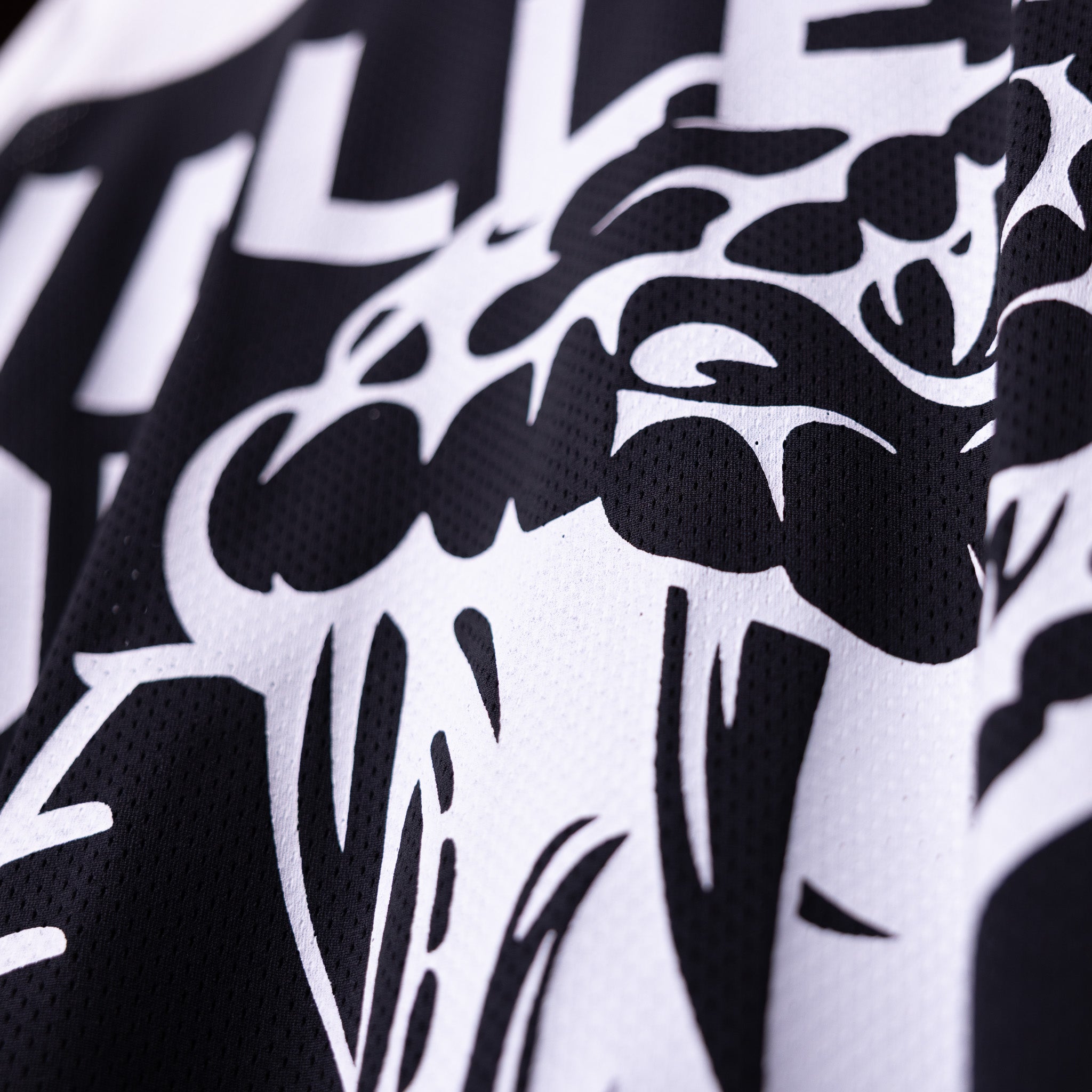 SM'23 Mesh Long-sleeve Jersey fabric closeup showing black and white graphic design detail