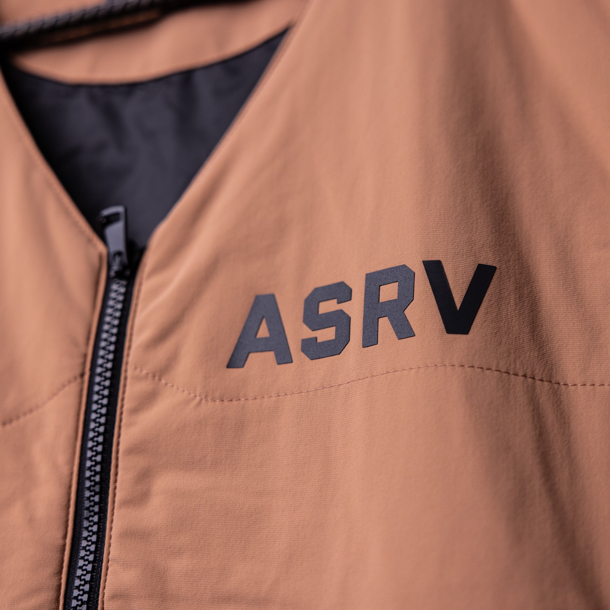 FA'22 Insulated Gilet Vest in tan, worn by model, front detail showing ASRV logo and zipper