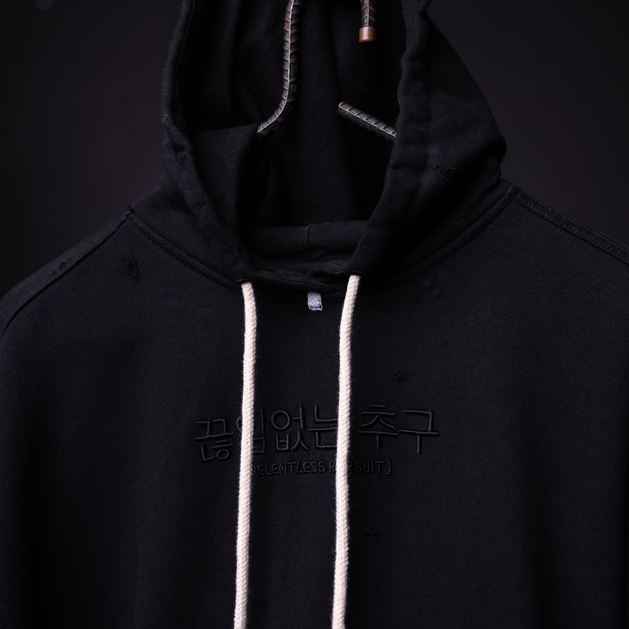 FA'20 Distressed Hoodie in black with white drawstrings, front view on model