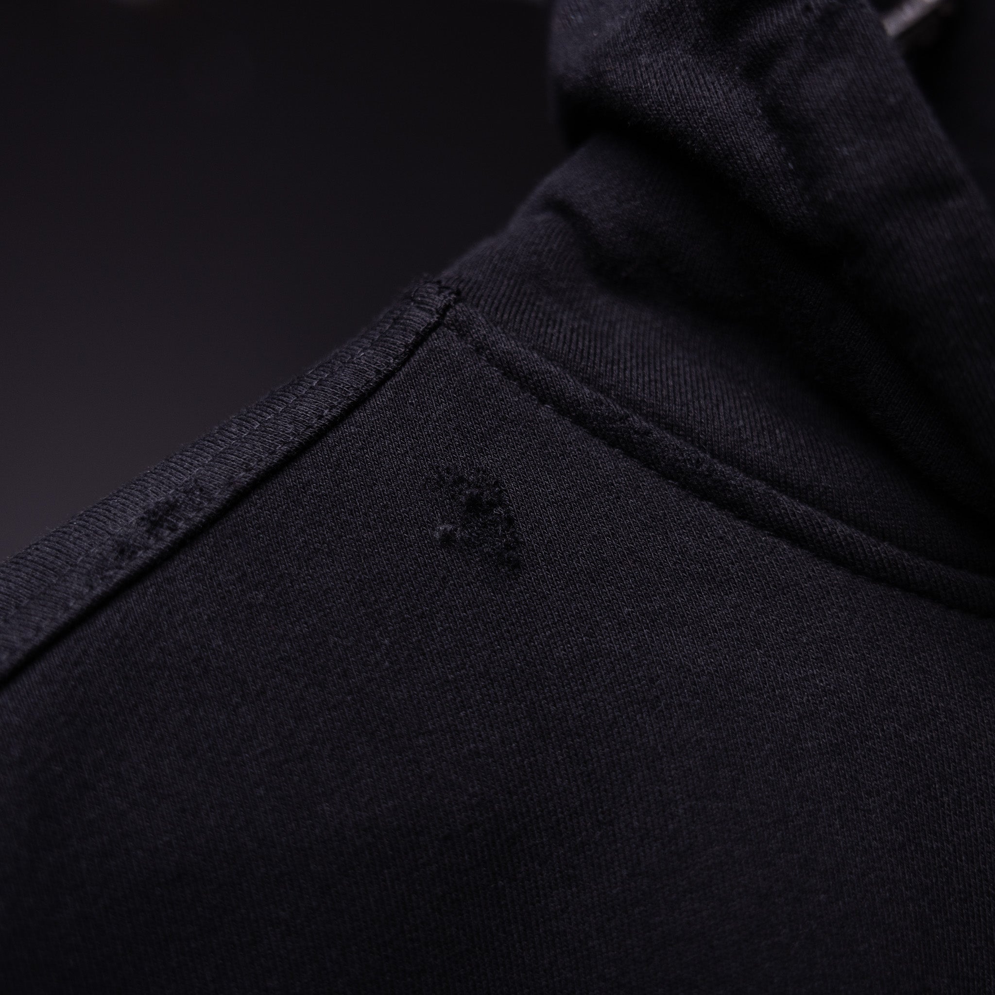 FA'20 Distressed Hoodie in black, fabric detail closeup showing texture and distressing