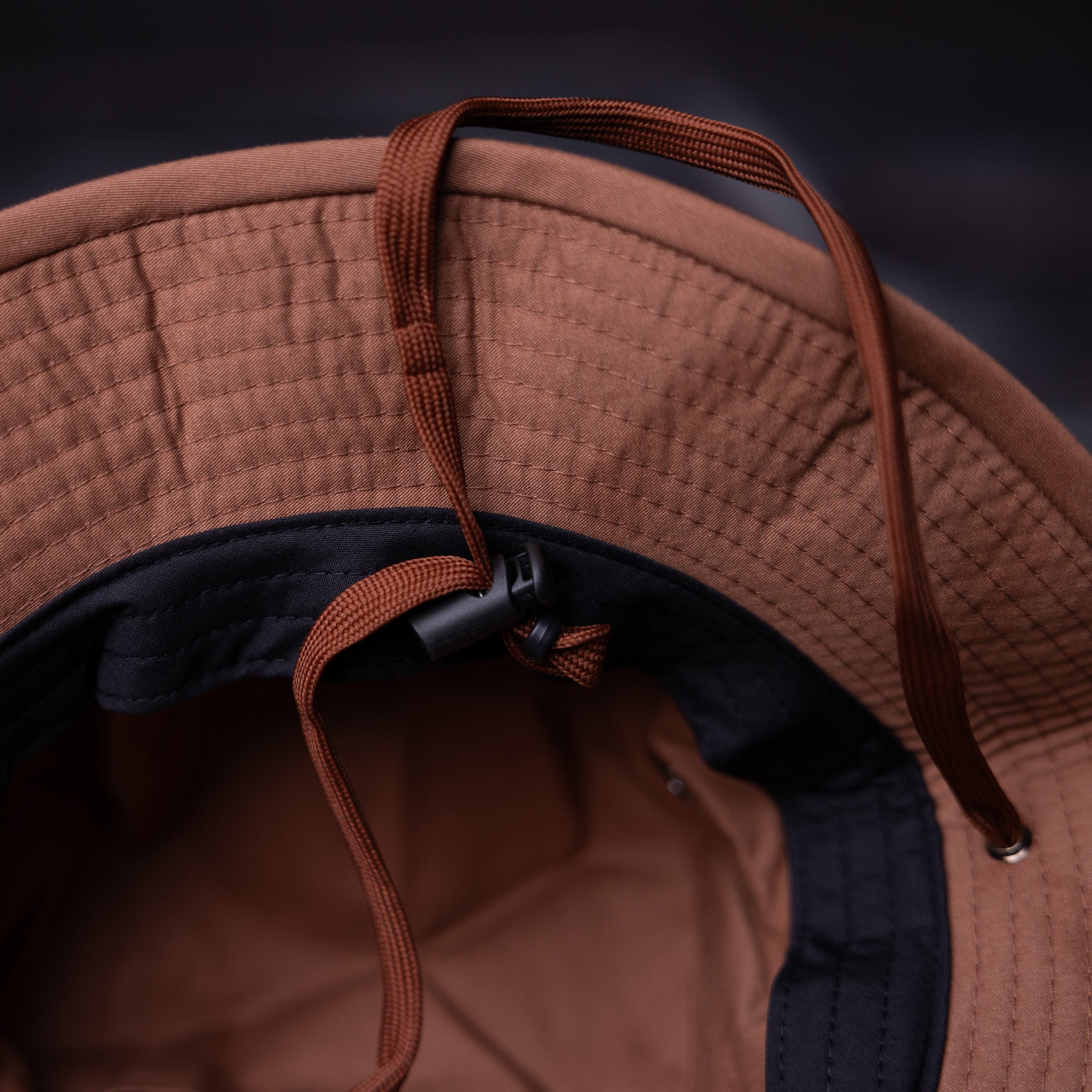 Flatlay FA'22 Clay Boonie Hat in terracotta, detail view of brim and drawstring