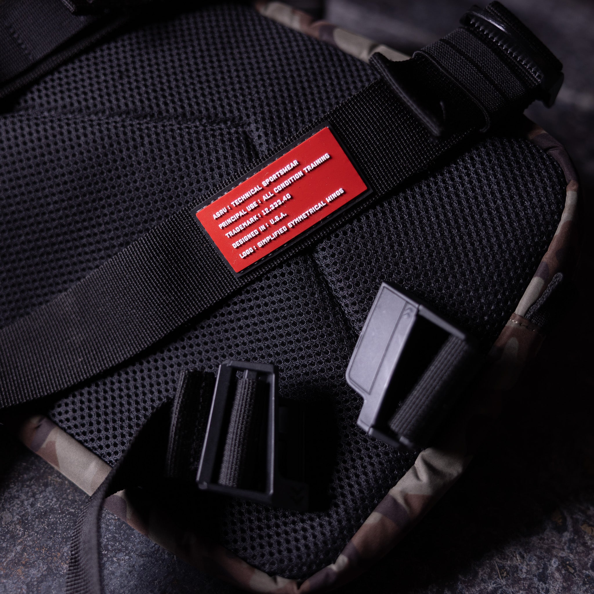 Flatlay SP'19 Trail Pack Chest Rig in black, top view with straps and red label