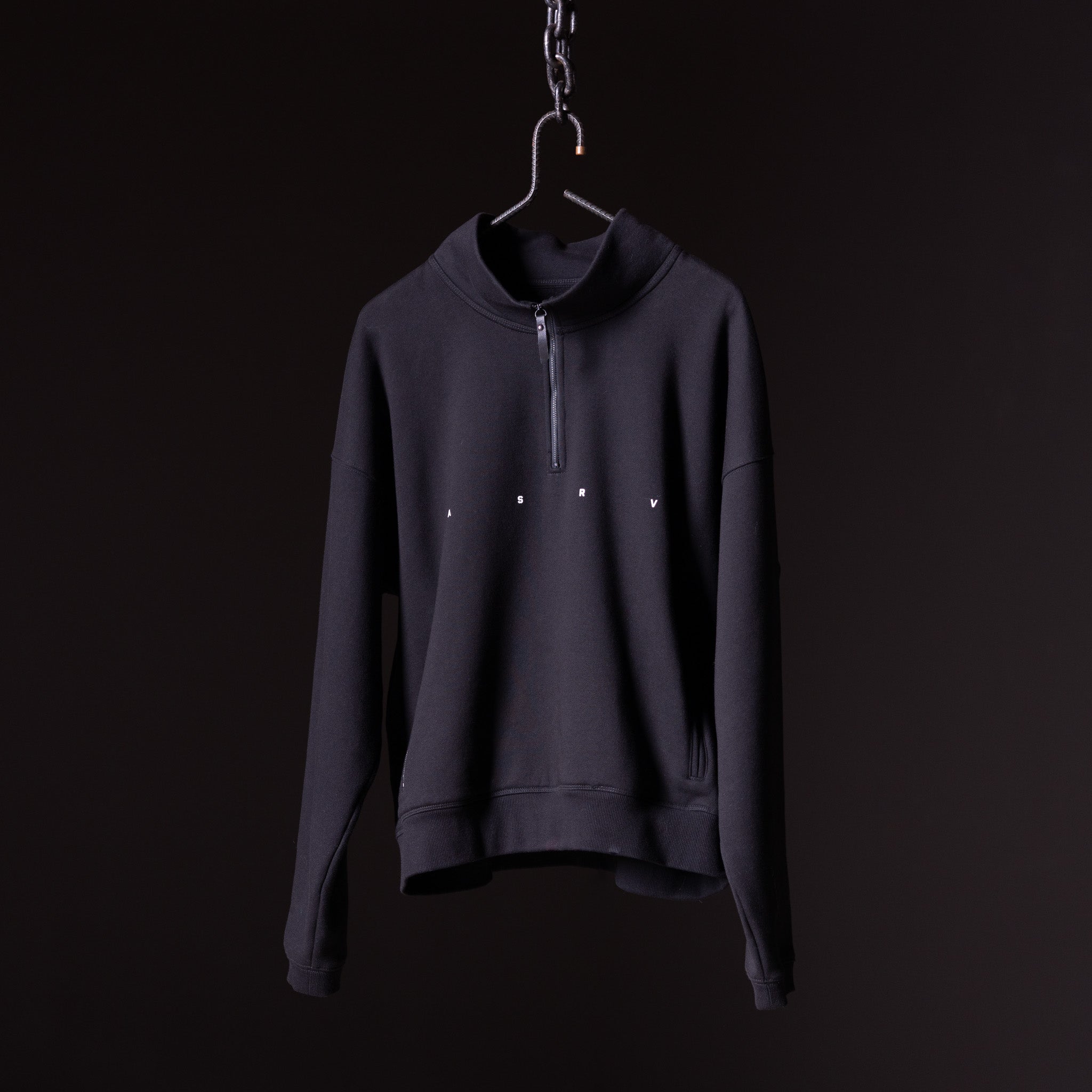 Navy quarter zip sweatshirt on hanger against black background, front view
