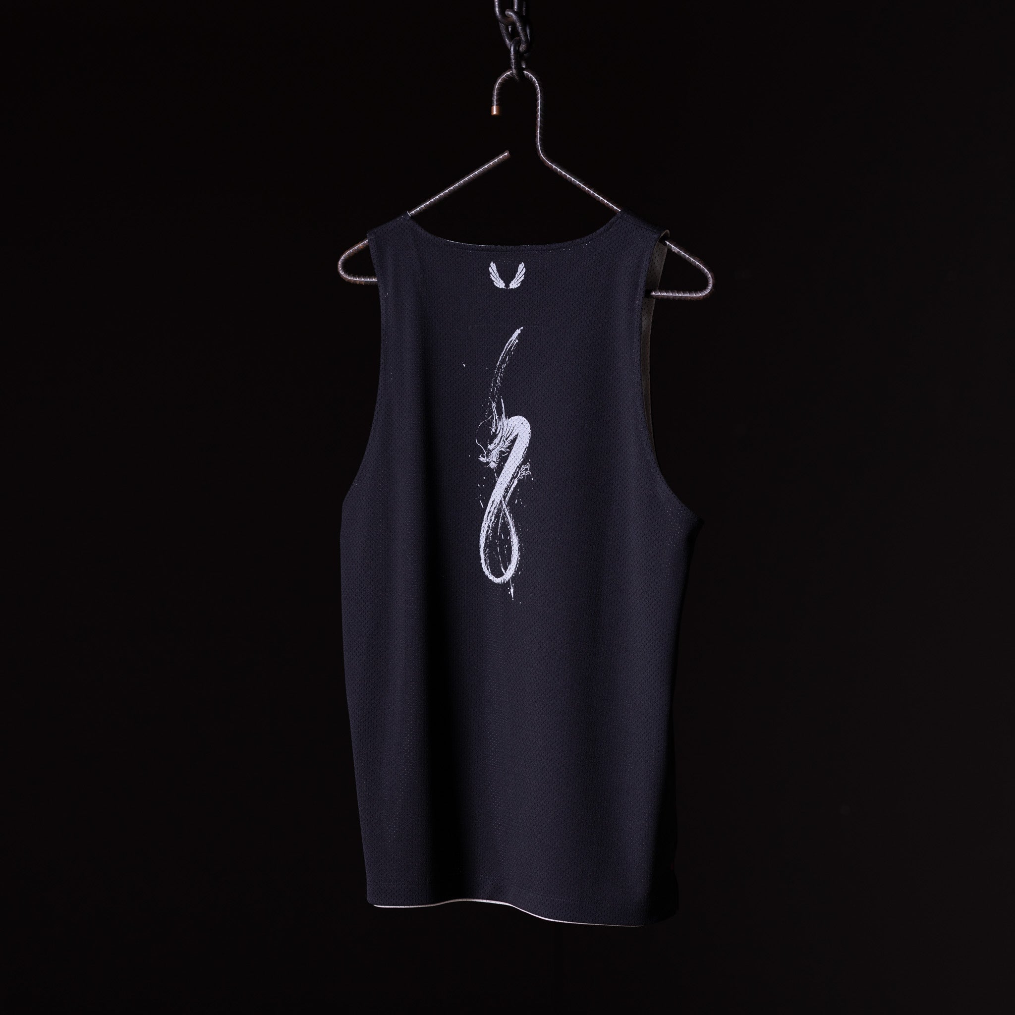 SM'23 Mesh Reversible Pinnie in black on hanger, front view with graphic design