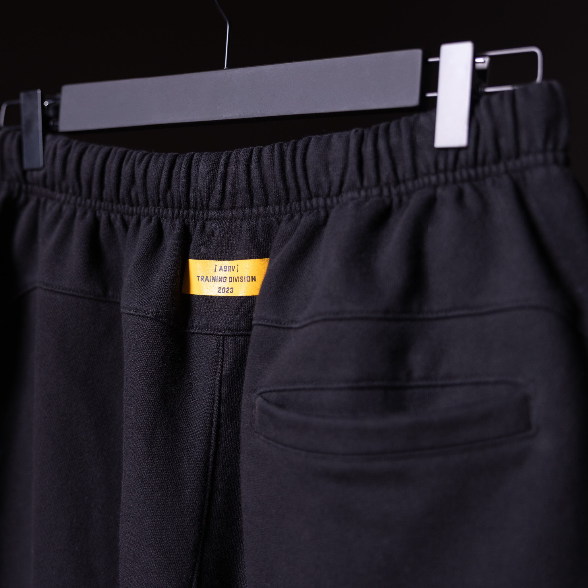 FA'23 Straight Leg Jogger in black, displayed on hanger with yellow Training Division label visible