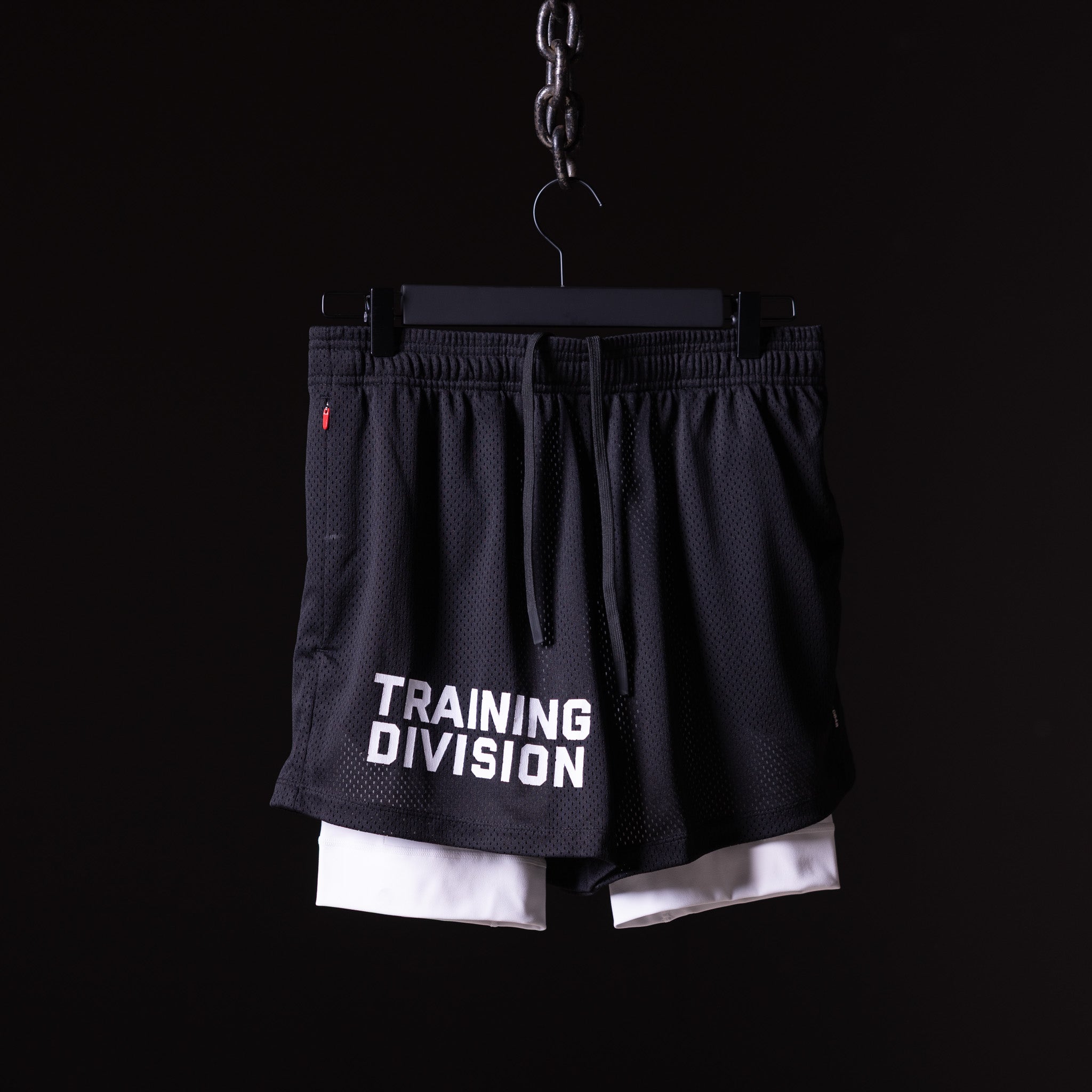 FA'23 Training Division Mesh Shorts in black and white, front view on hanger
