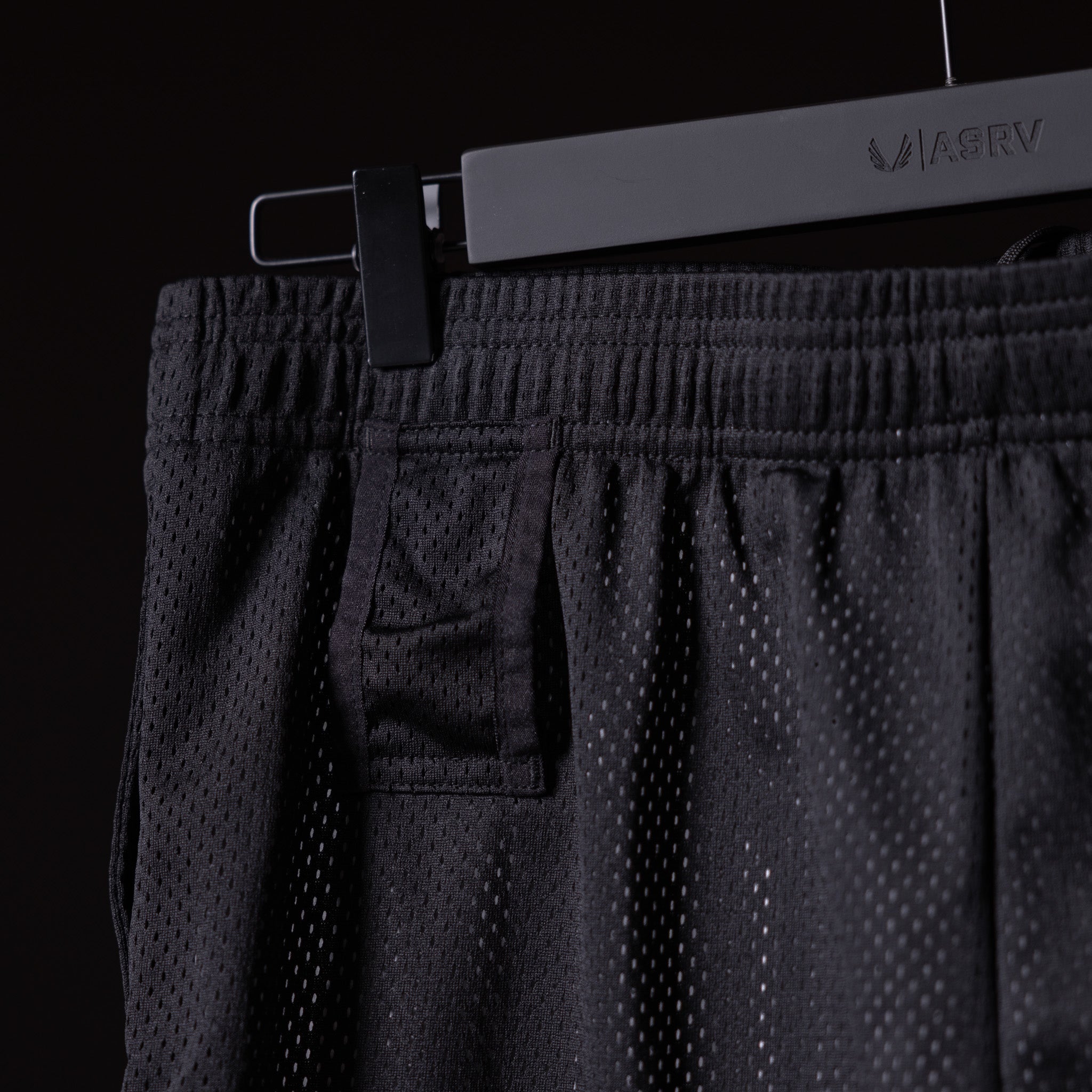 FA'23 Training Division Mesh Shorts in black on hanger, detail view