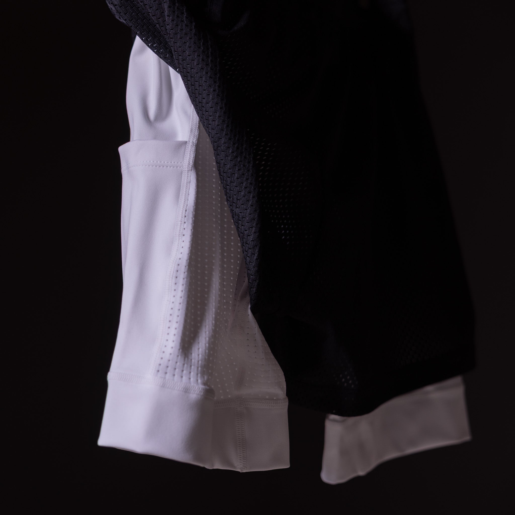 FA'23 Training Division Mesh Shorts in white and black, side view on model
