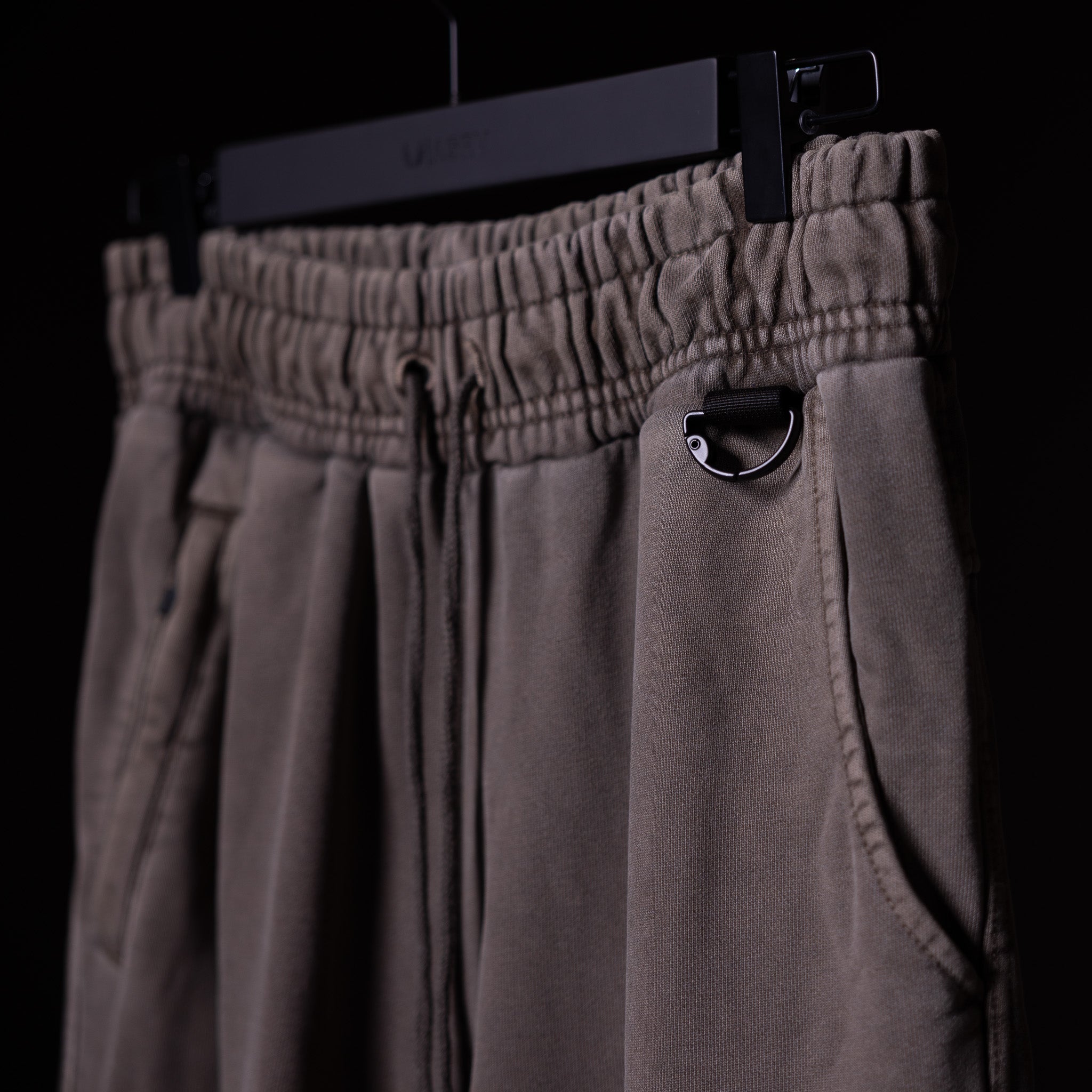 WN'20 Terry Relaxed Jogger in taupe, hanging on display with detail of pocket and drawstring