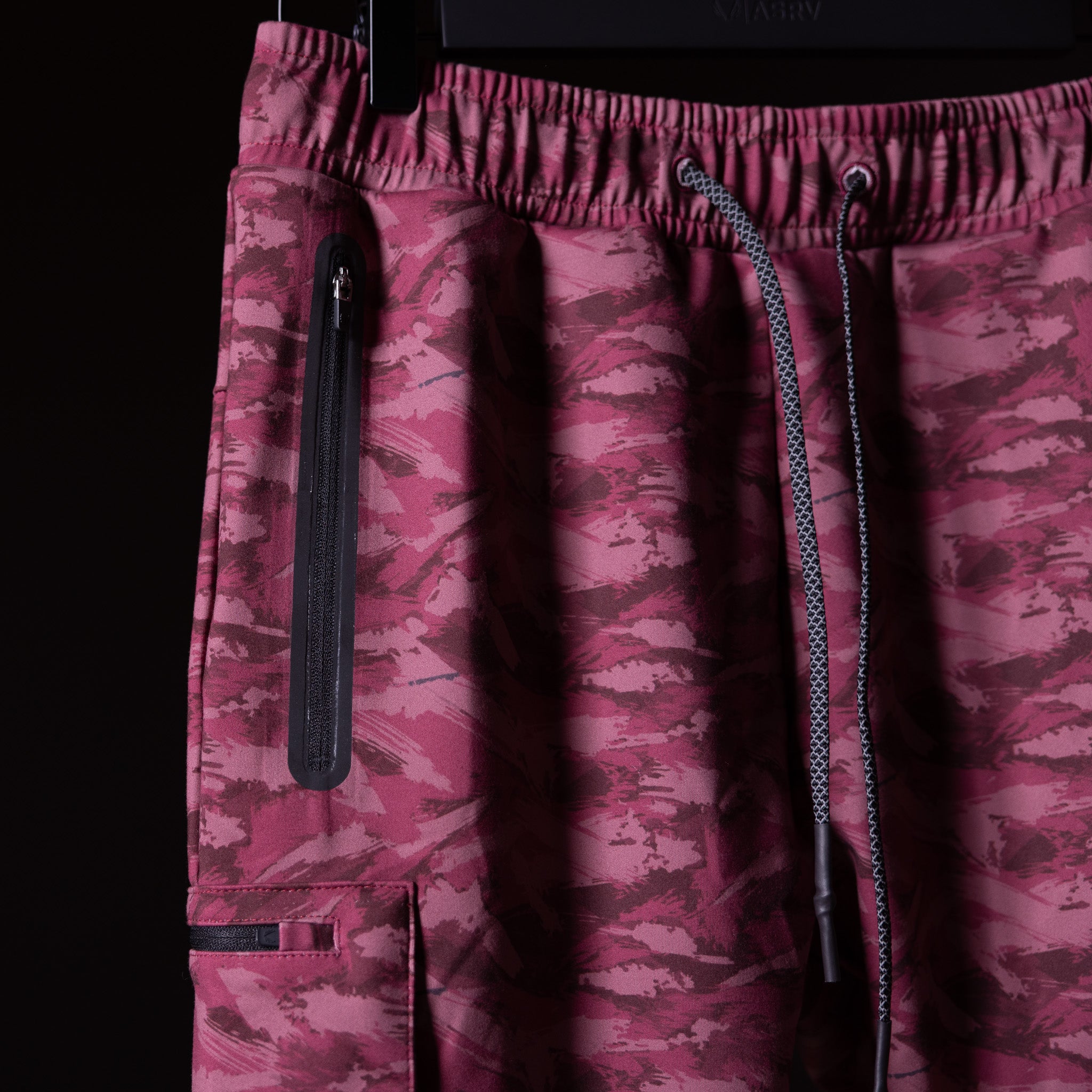 Brushed camo cargo jogger in burgundy, detail shot of pocket and drawstring