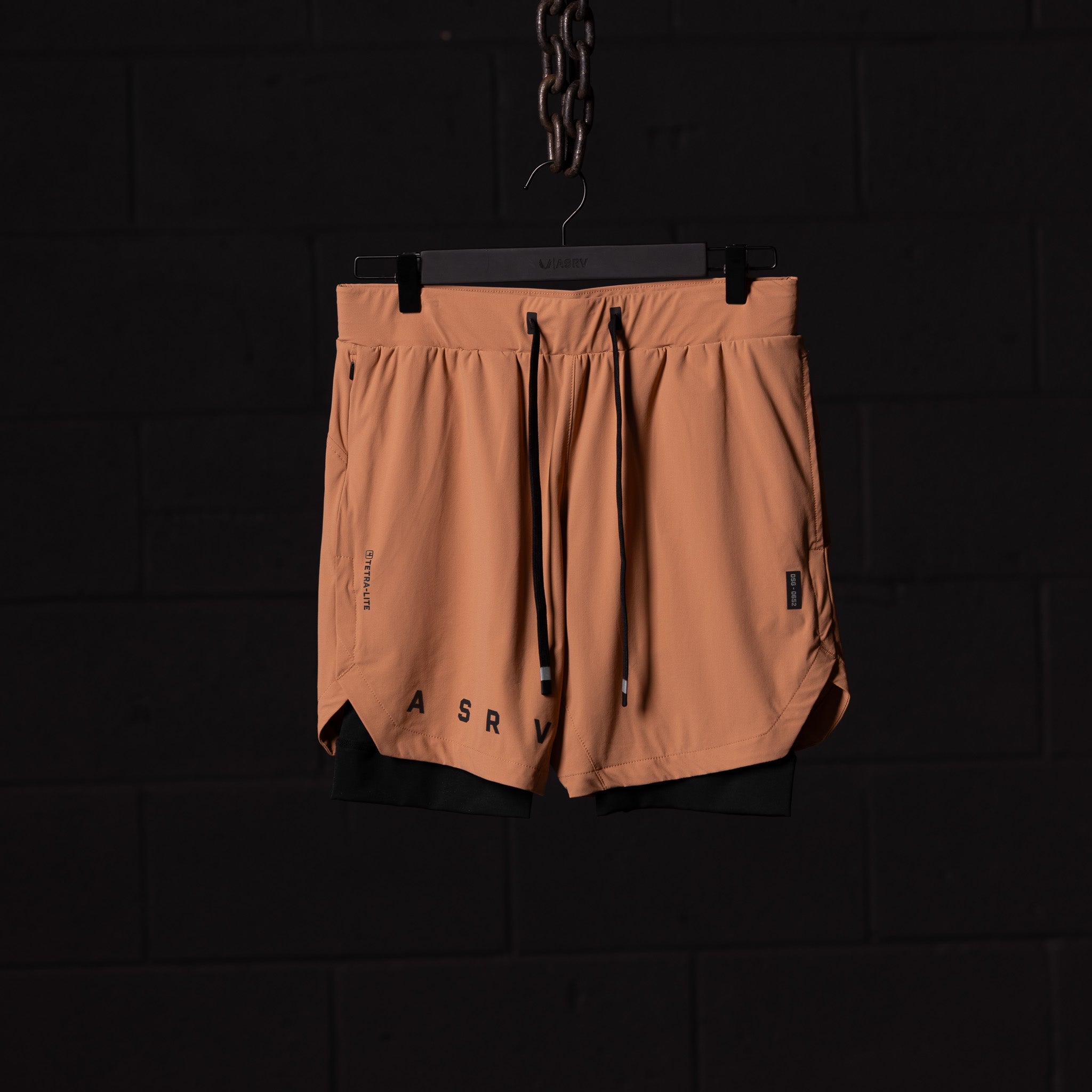FA'22 7" Liner Short in peach, displayed on hanger against dark background