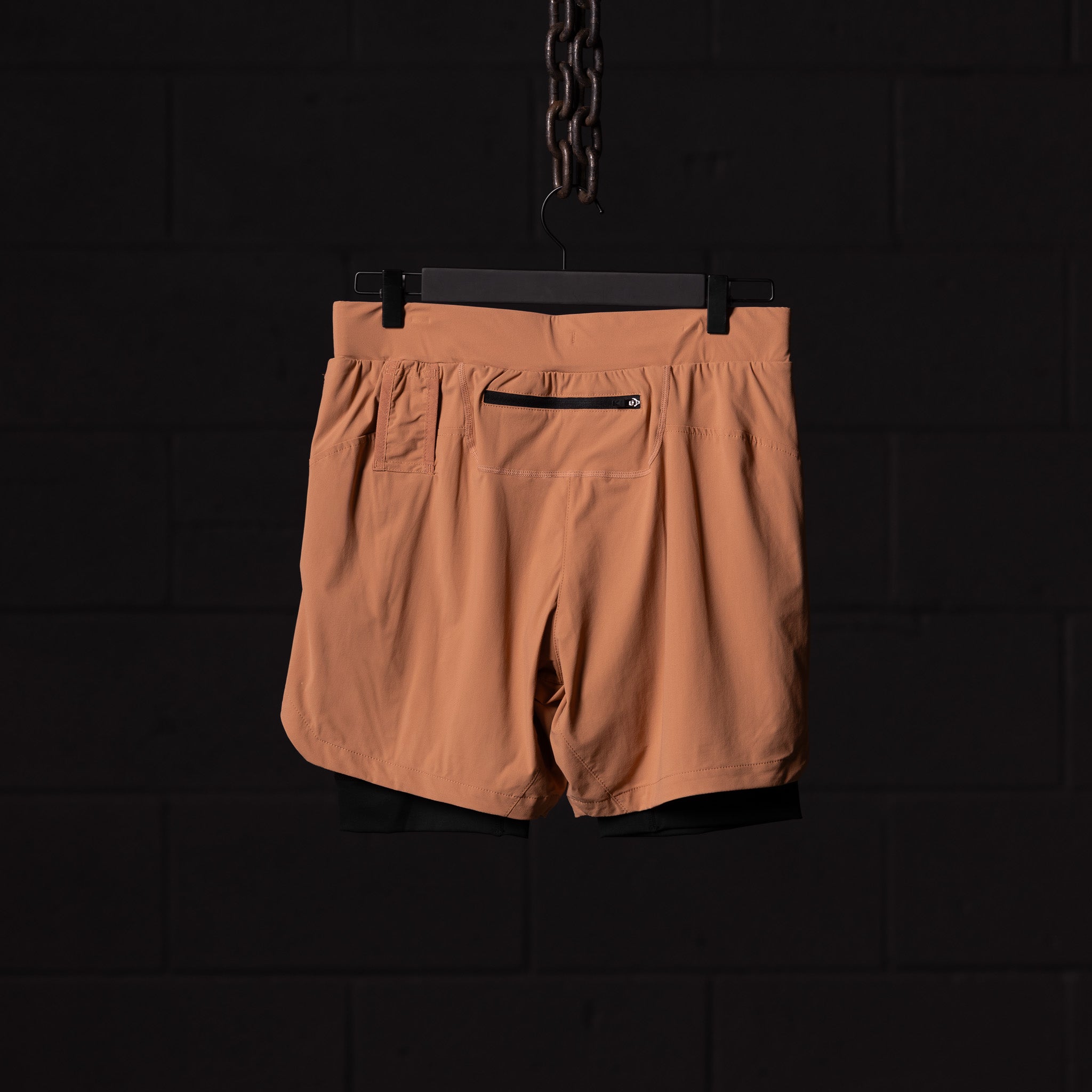 flatlay FA'22 7" Liner Short in tan/caramel, back view on hanger