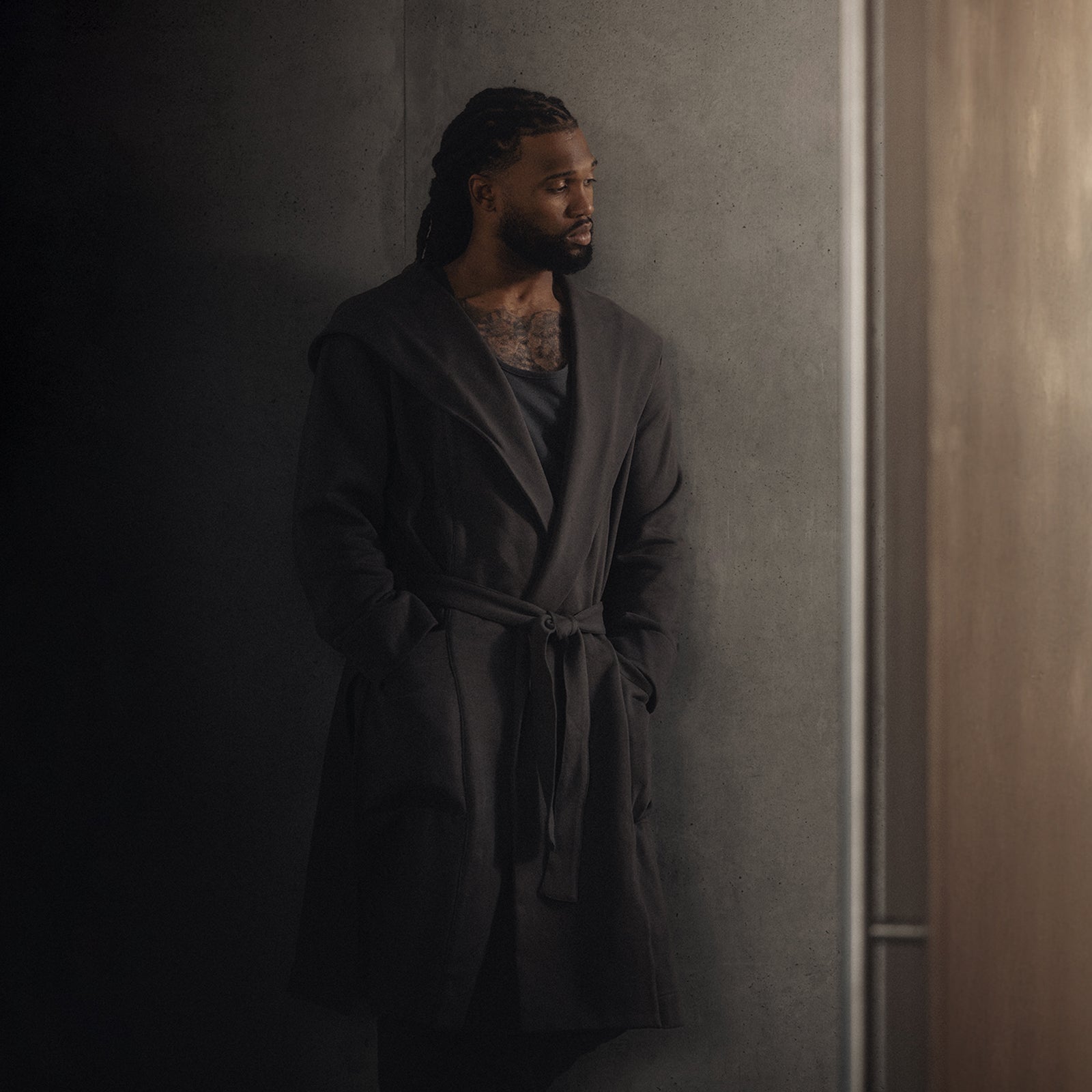 ASRV x Walden Heavyweight Robe in Carbon, worn by model against concrete wall