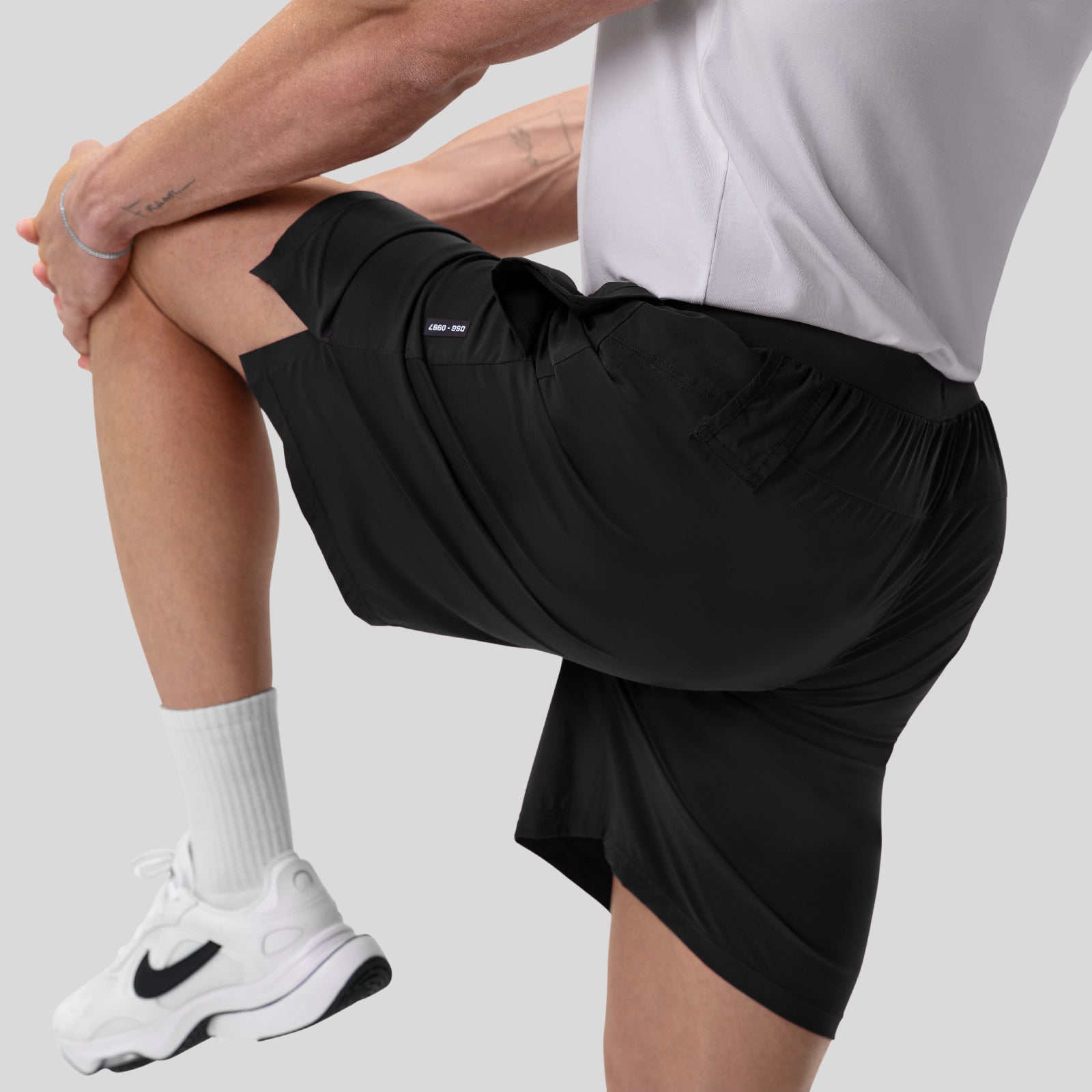 Aerotex™ 8" Training Short in black, worn by model demonstrating fit and stretching